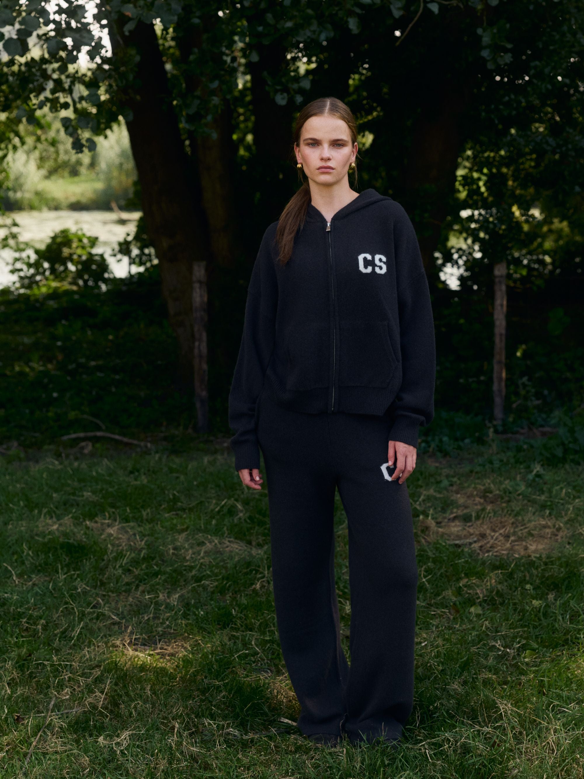 Woman wearing cocoa bean CASPARA woolknit straight leg pants and a matching zip hoodie outdoors.