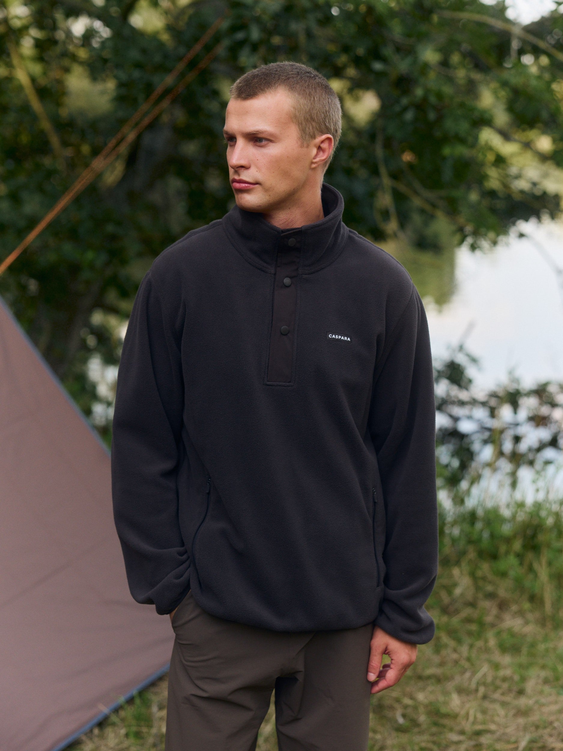 Man wearing a cocoa bean polar fleece half-snap pullover outdoors.