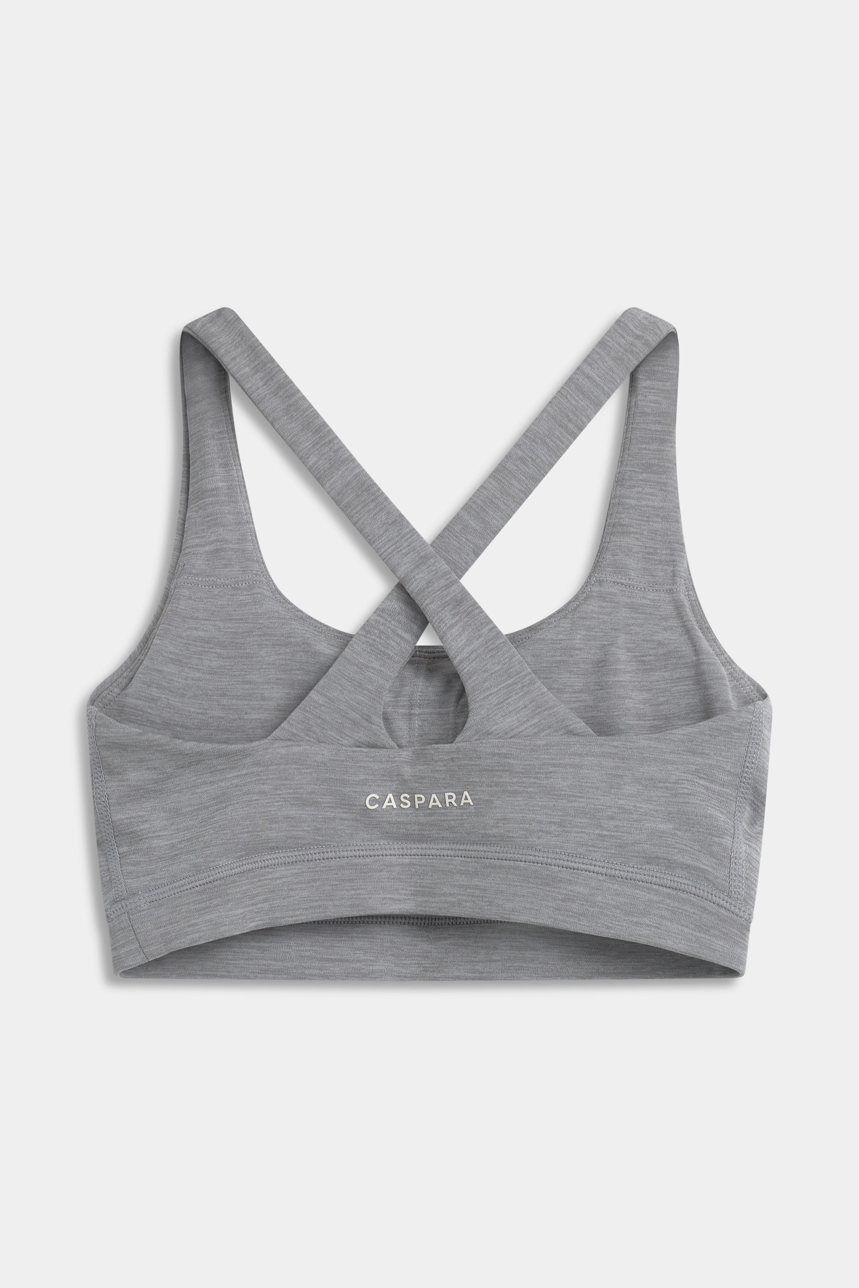 Back view of a grey melange CASPARA Cloudform crossback sports bra with crossed straps.