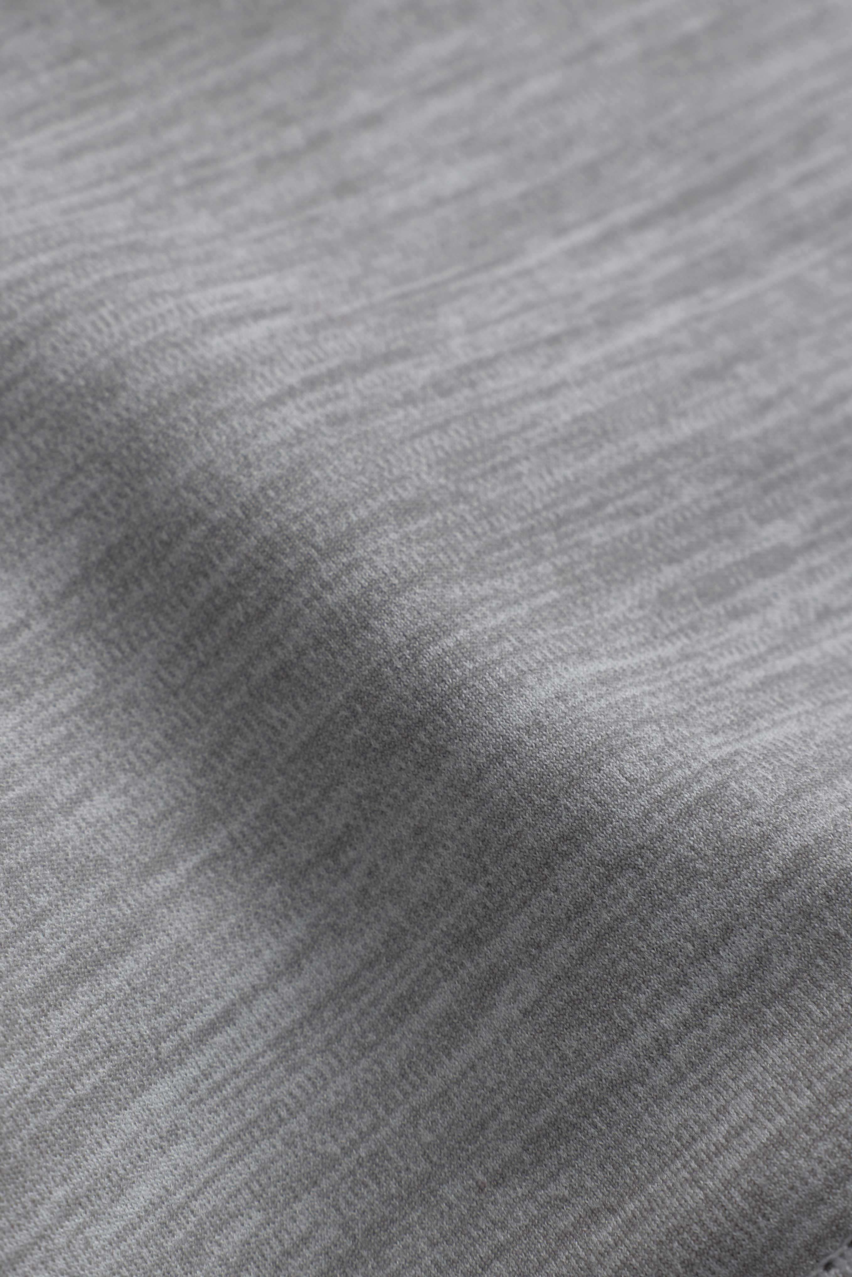 Close-up of the grey melange Cloudform fabric texture on a CASPARA sports bra.