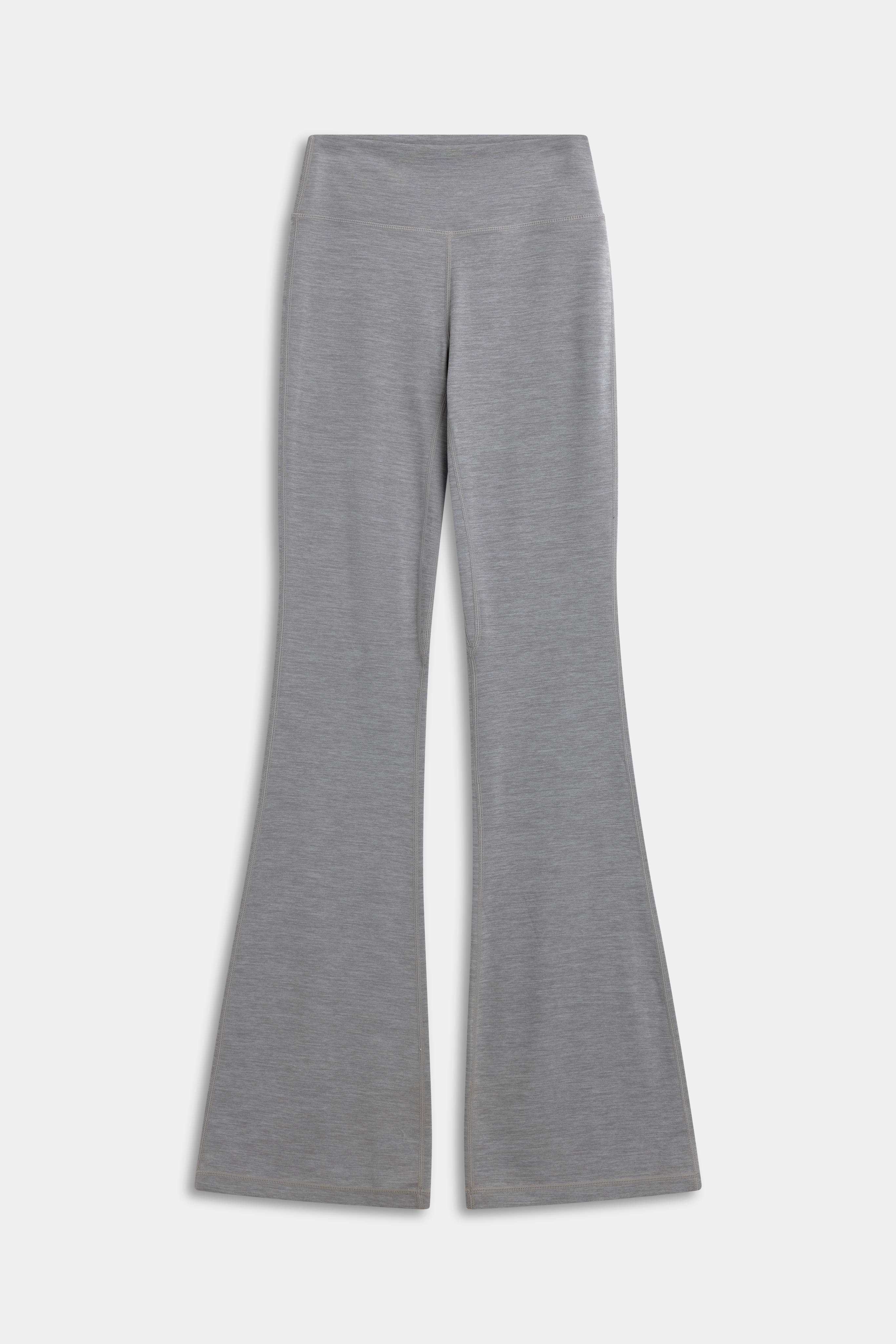 CASPARA Cloudform flared yoga pants in grey melange, front view on a neutral background.