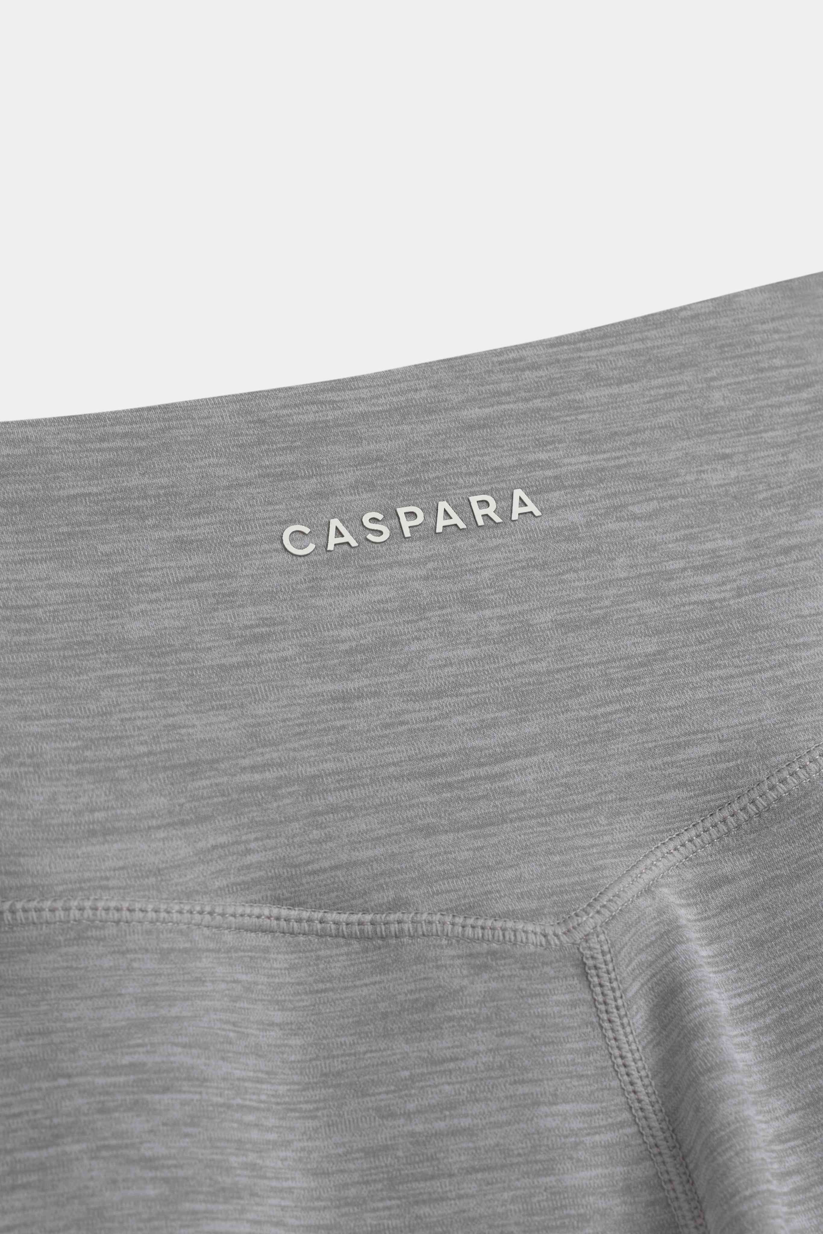 Close-up of the grey melange CASPARA Cloudform yoga pant waistband and logo.