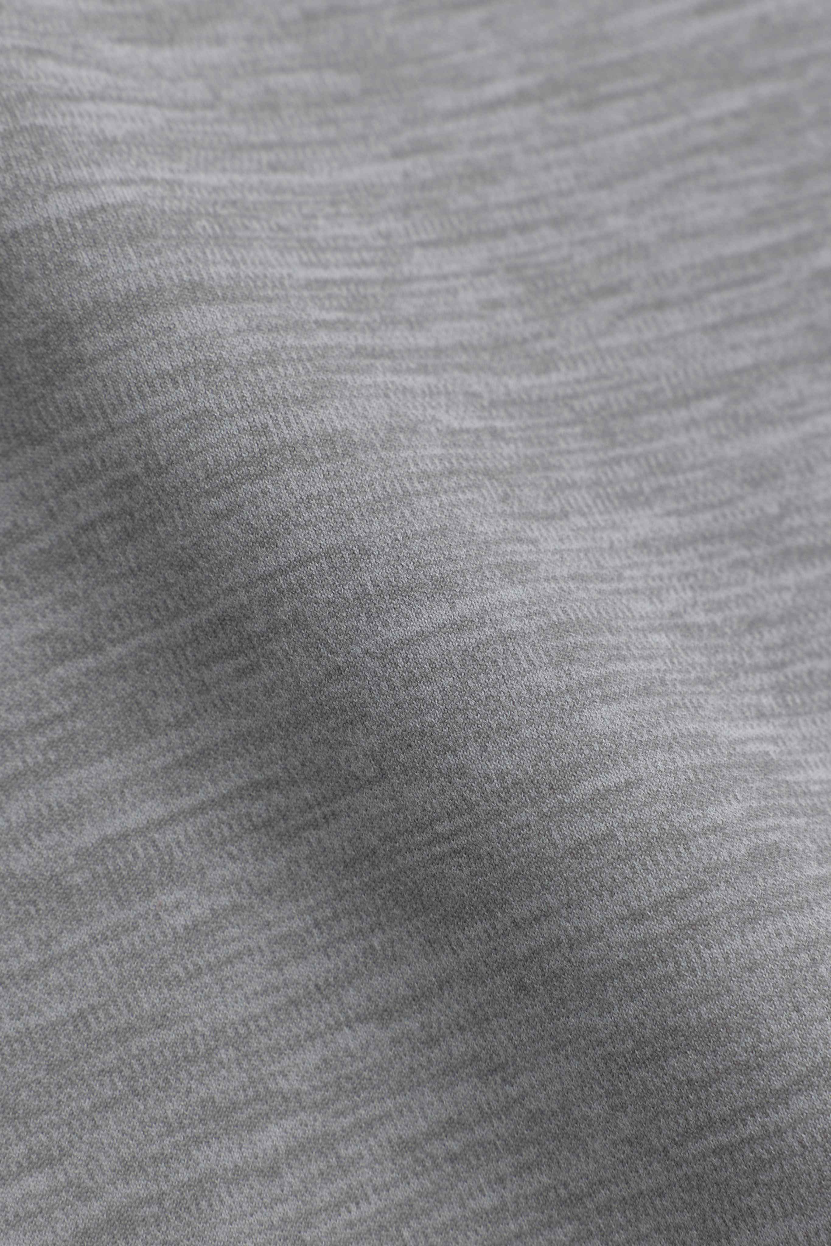 Close-up of the soft grey melange Cloudform fabric on CASPARA yoga pants.