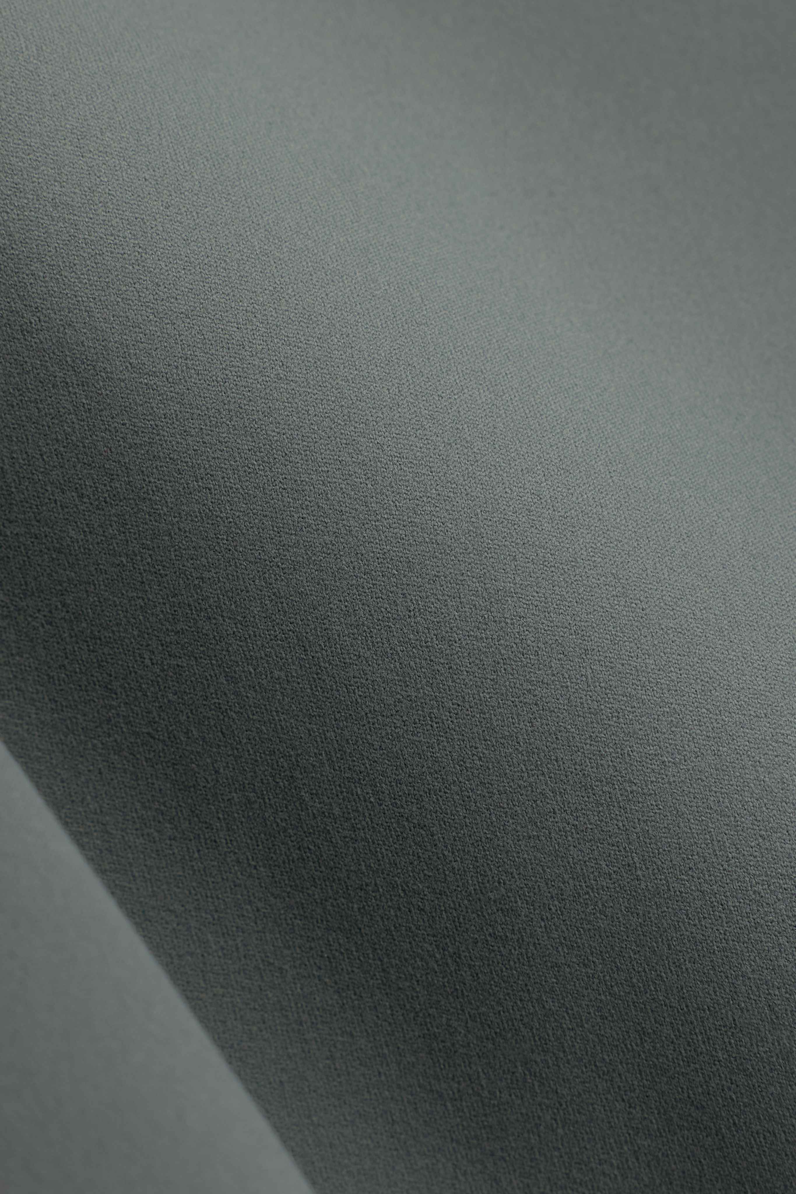 Close-up of the smooth, brushed matte khaki CASPARA Cloudform fabric.