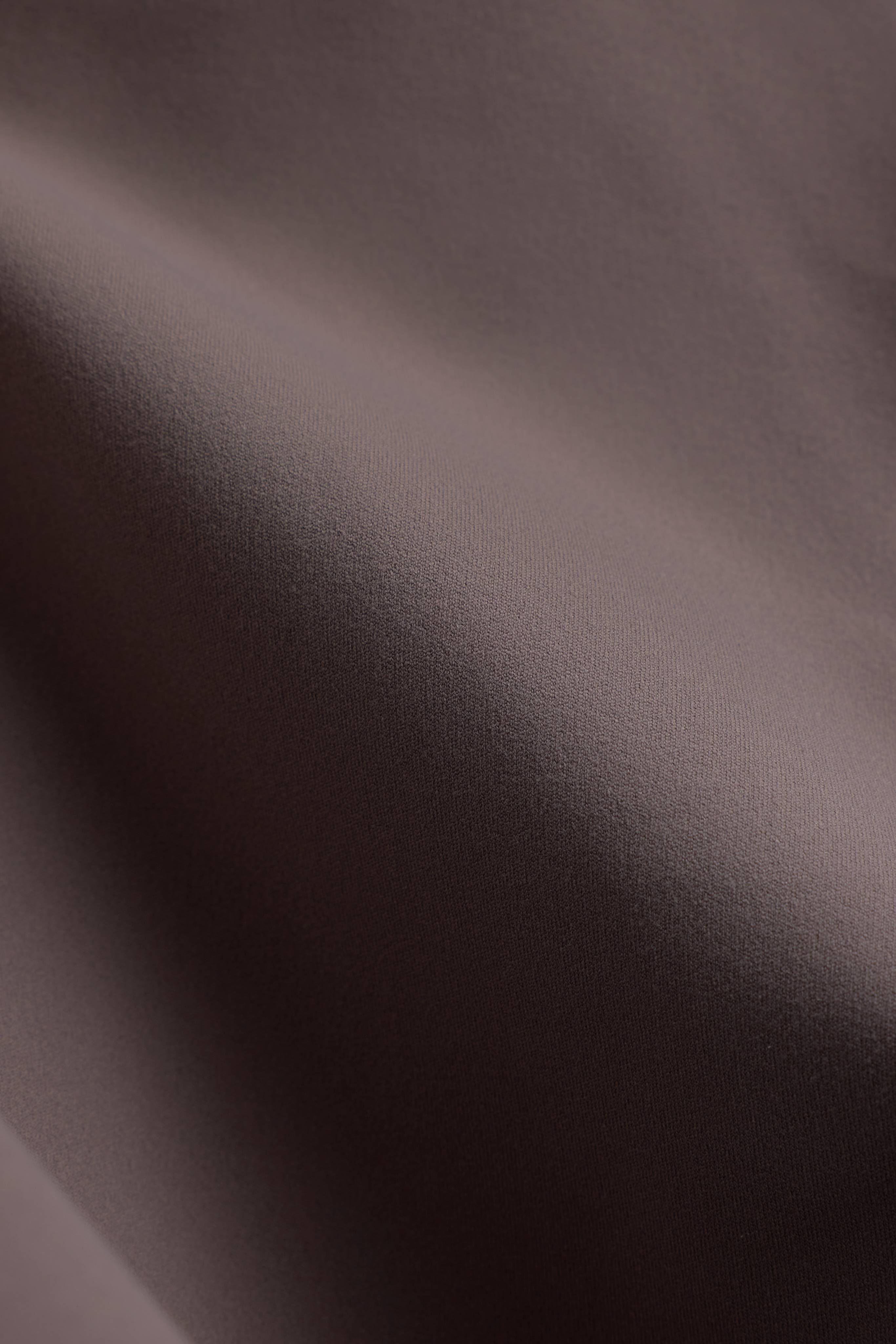 Close-up view of CASPARA walnut Cloudform fabric highlighting its smooth, matte texture.