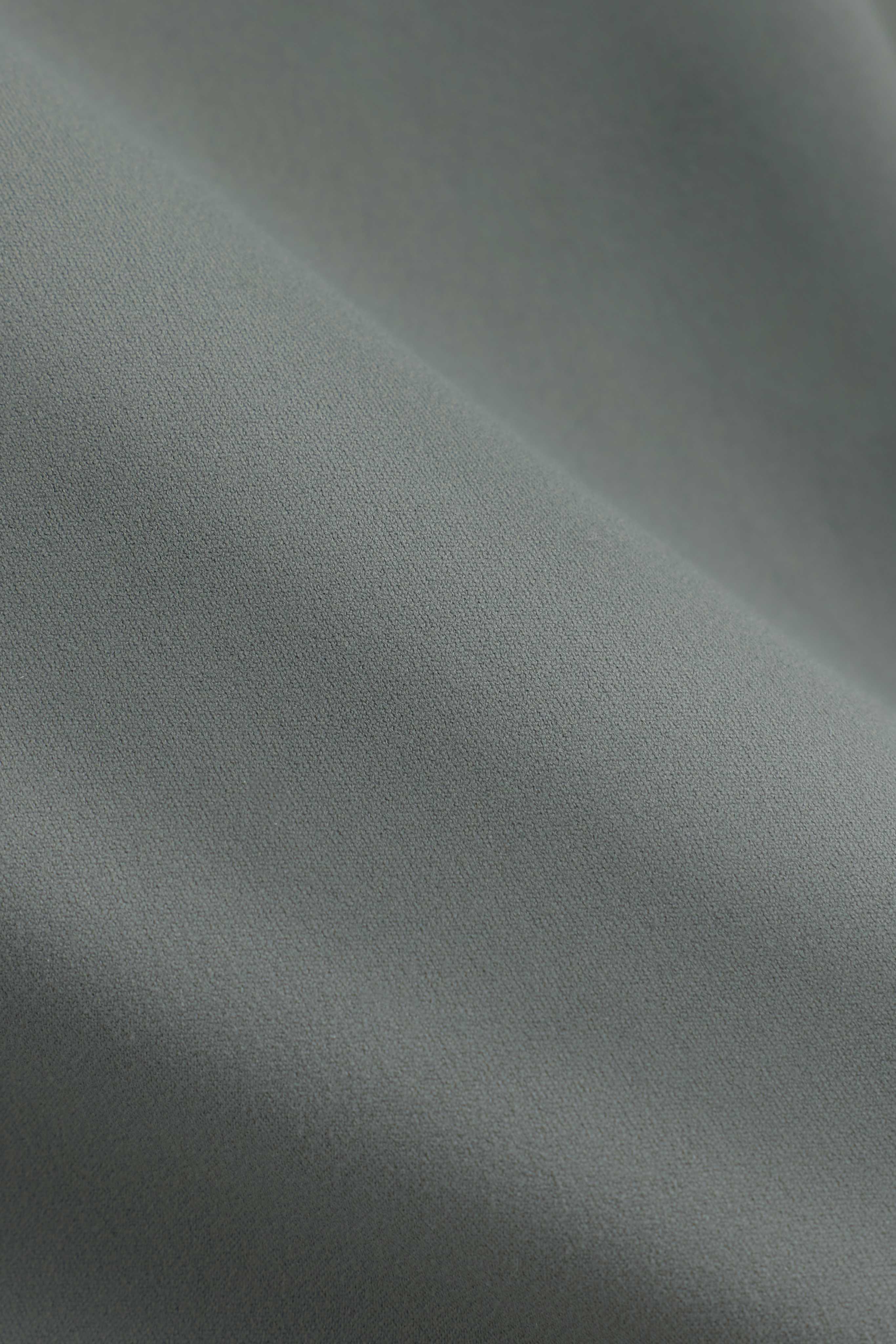 Close-up of the soft, matte khaki fabric texture of the CASPARA Cloudform Scrunch Top.