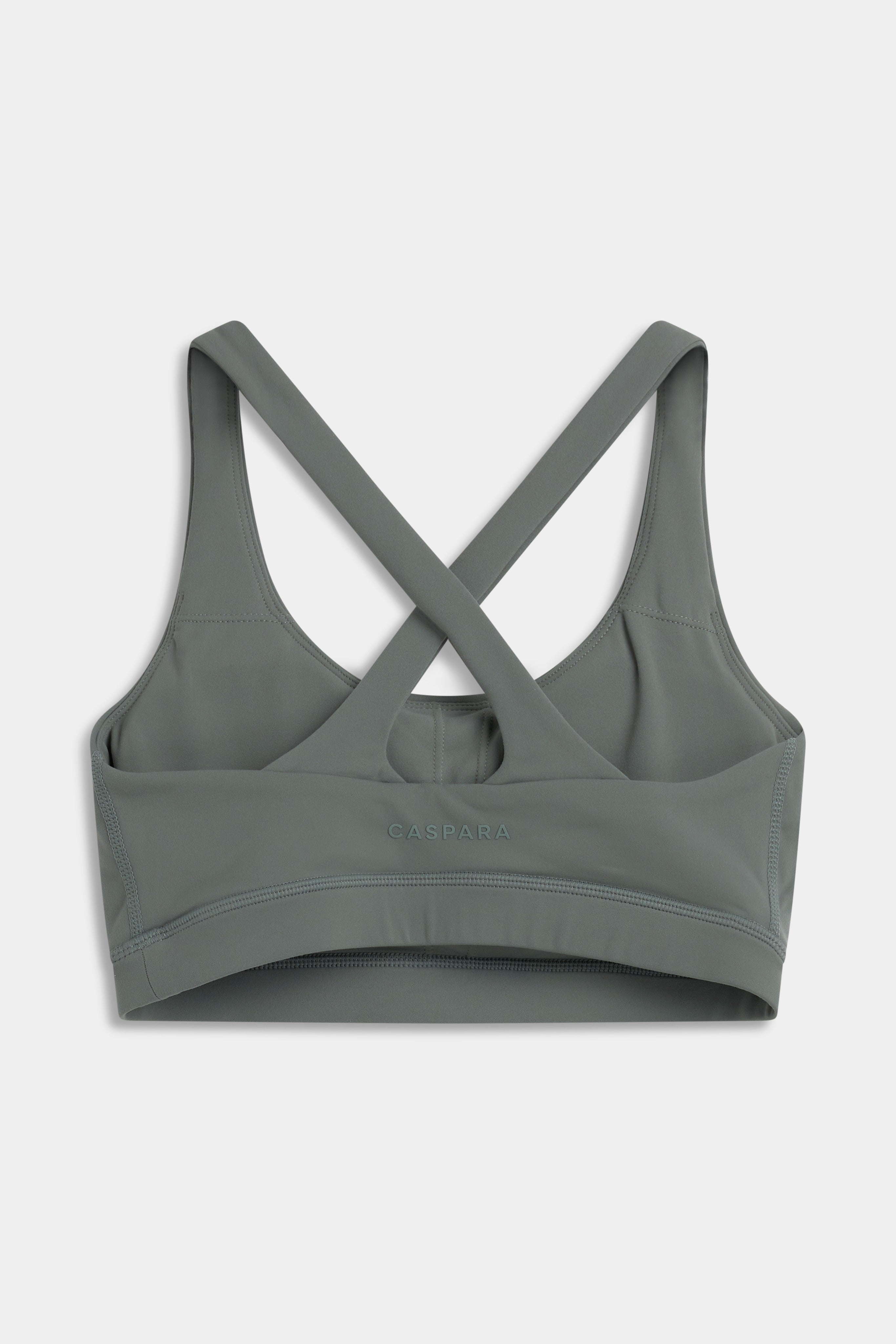 Back view of the khaki CASPARA Cloudform sports bra showing crossed straps and a keyhole back.