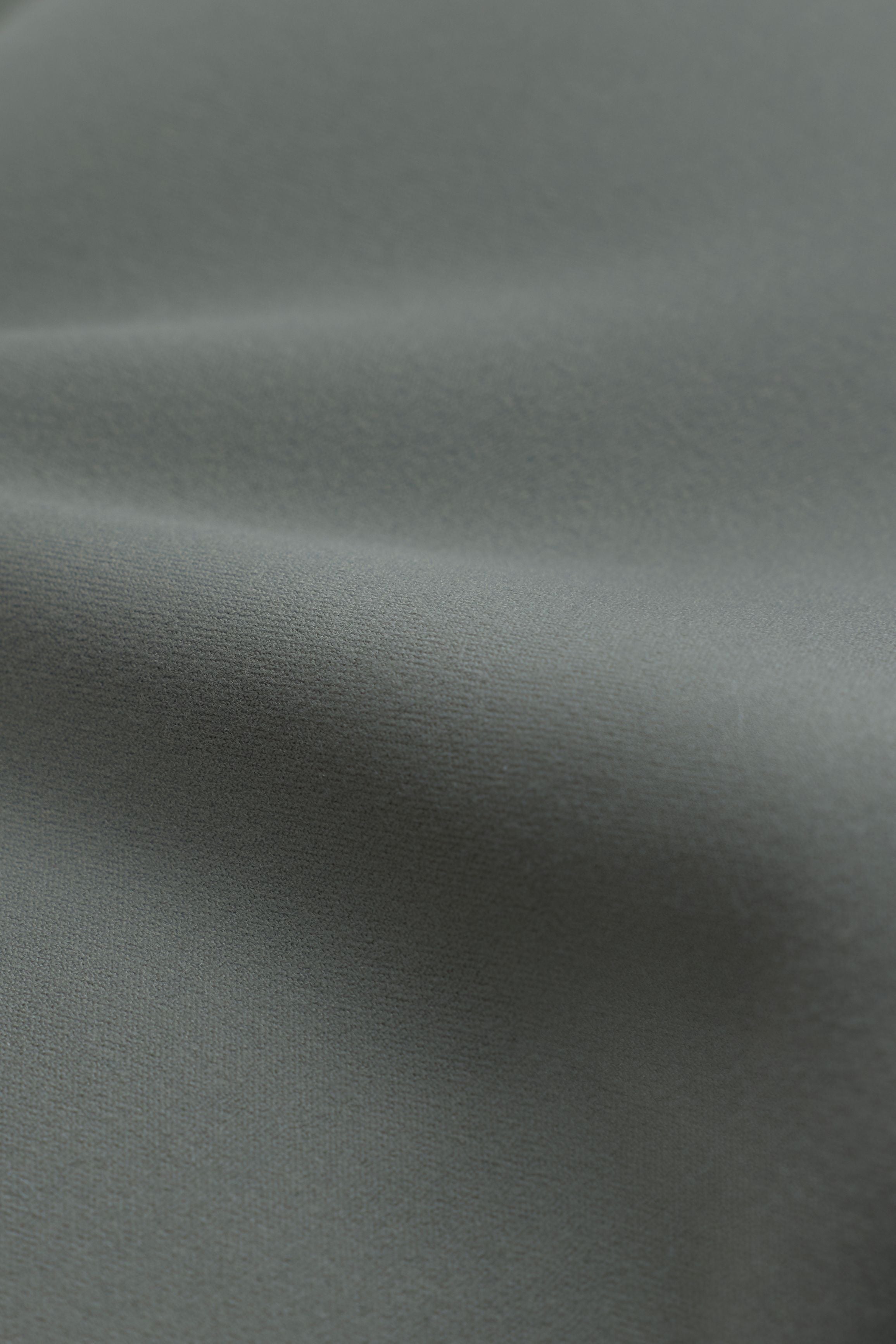Close-up of soft, smooth khaki Cloudform fabric showing subtle folds and texture.