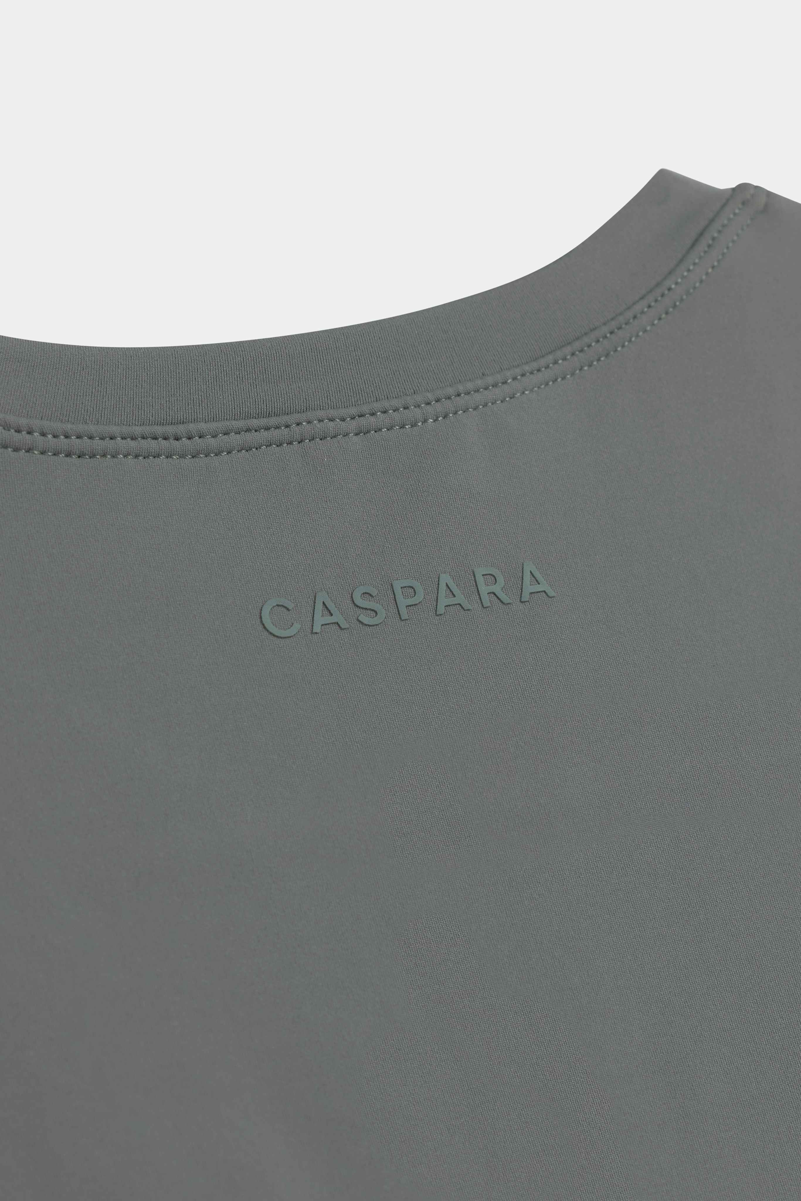 Close-up of the back neckline and tonal CASPARA logo on the khaki Cloudform short sleeve top.