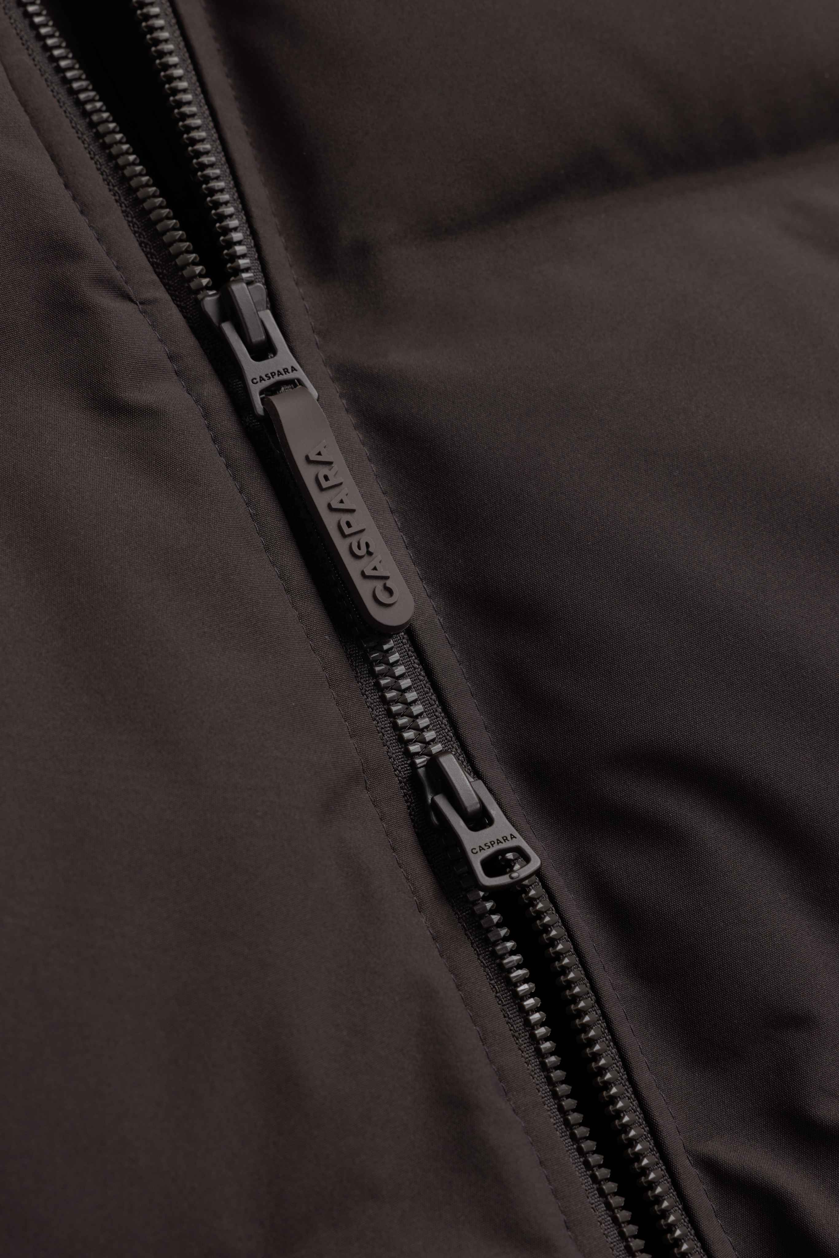 Close-up of the two-way front zipper on a cocoa bean CASPARA Boreal puffer jacket.
