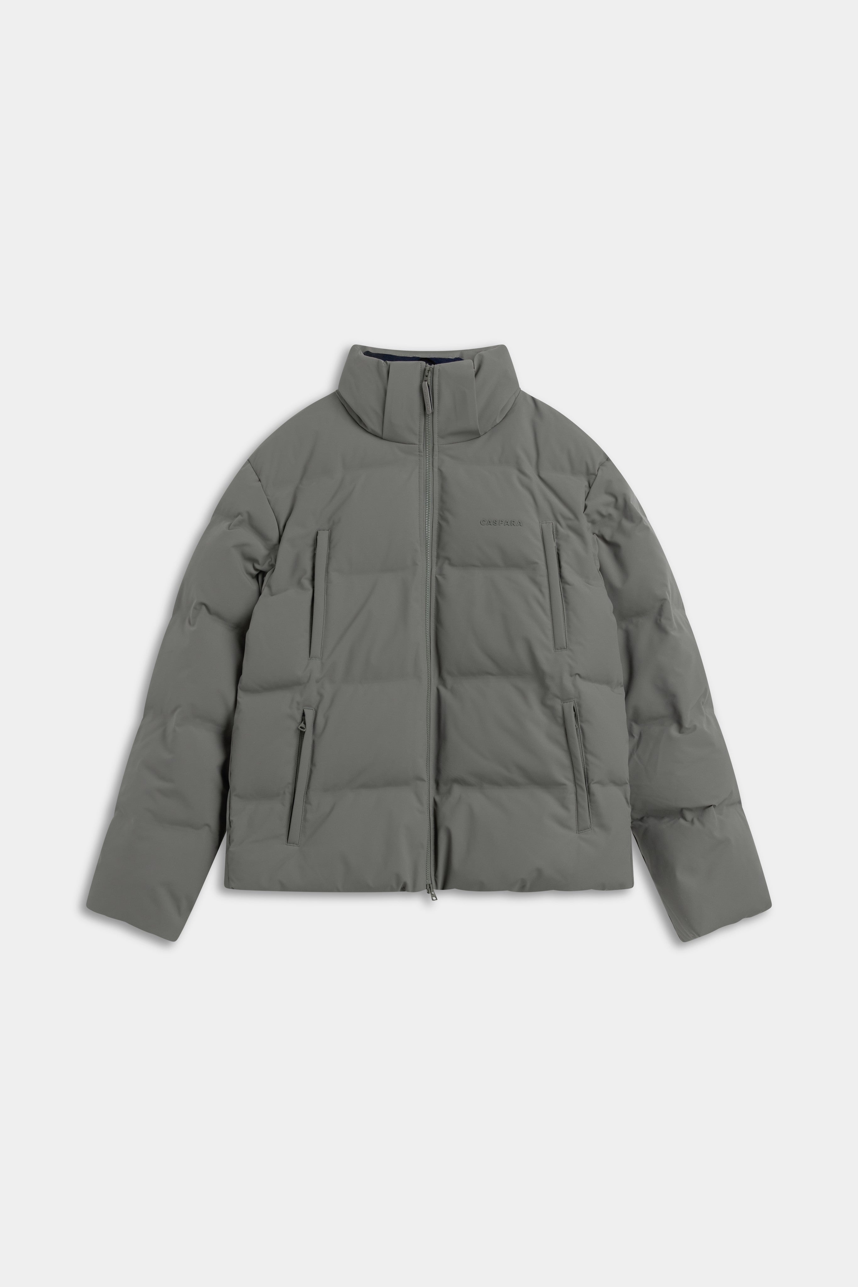 Khaki CASPARA Boreal Puffer Jacket laid flat on a light grey background.