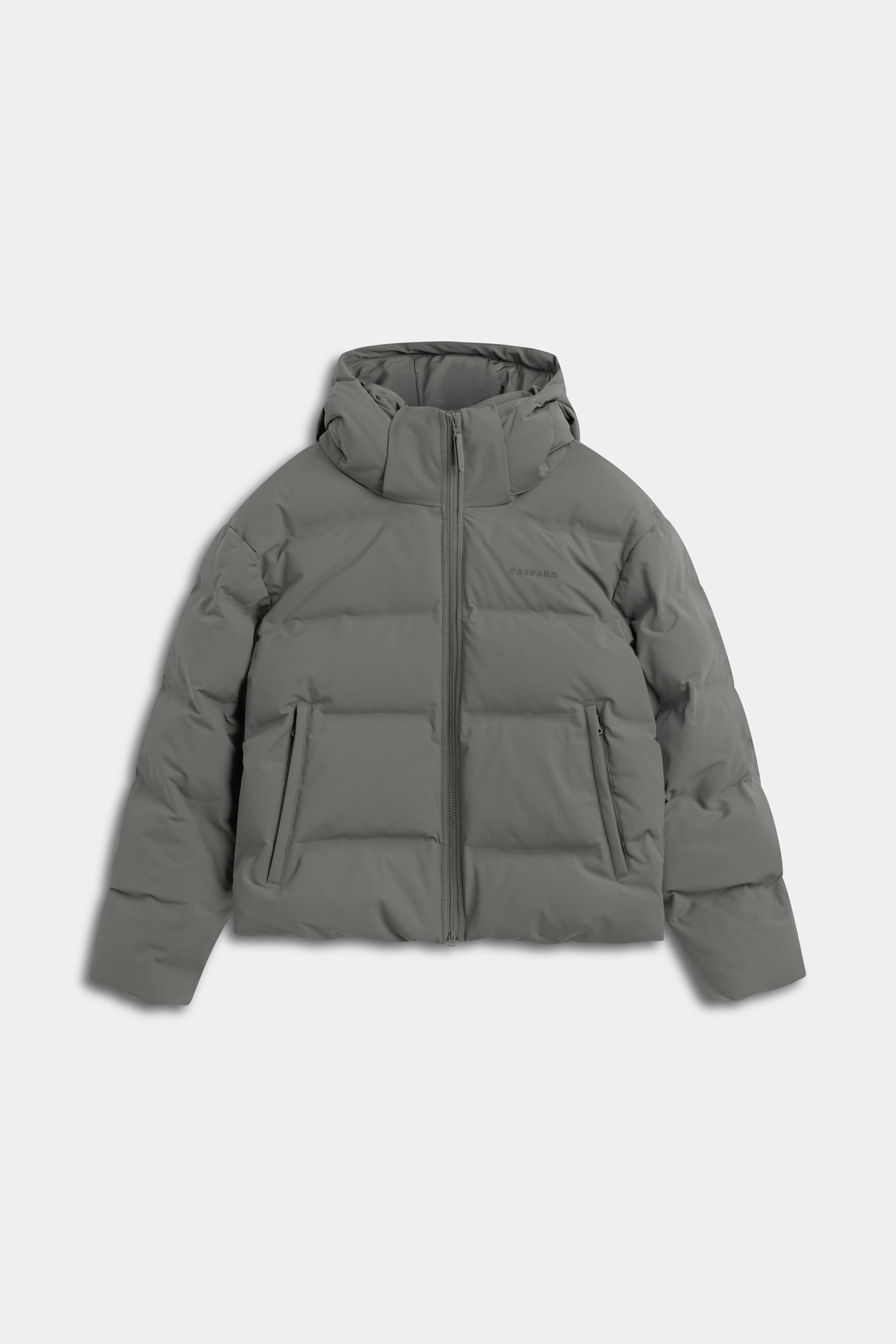 Khaki CASPARA Aurora puffer jacket with a full front zip and hood.