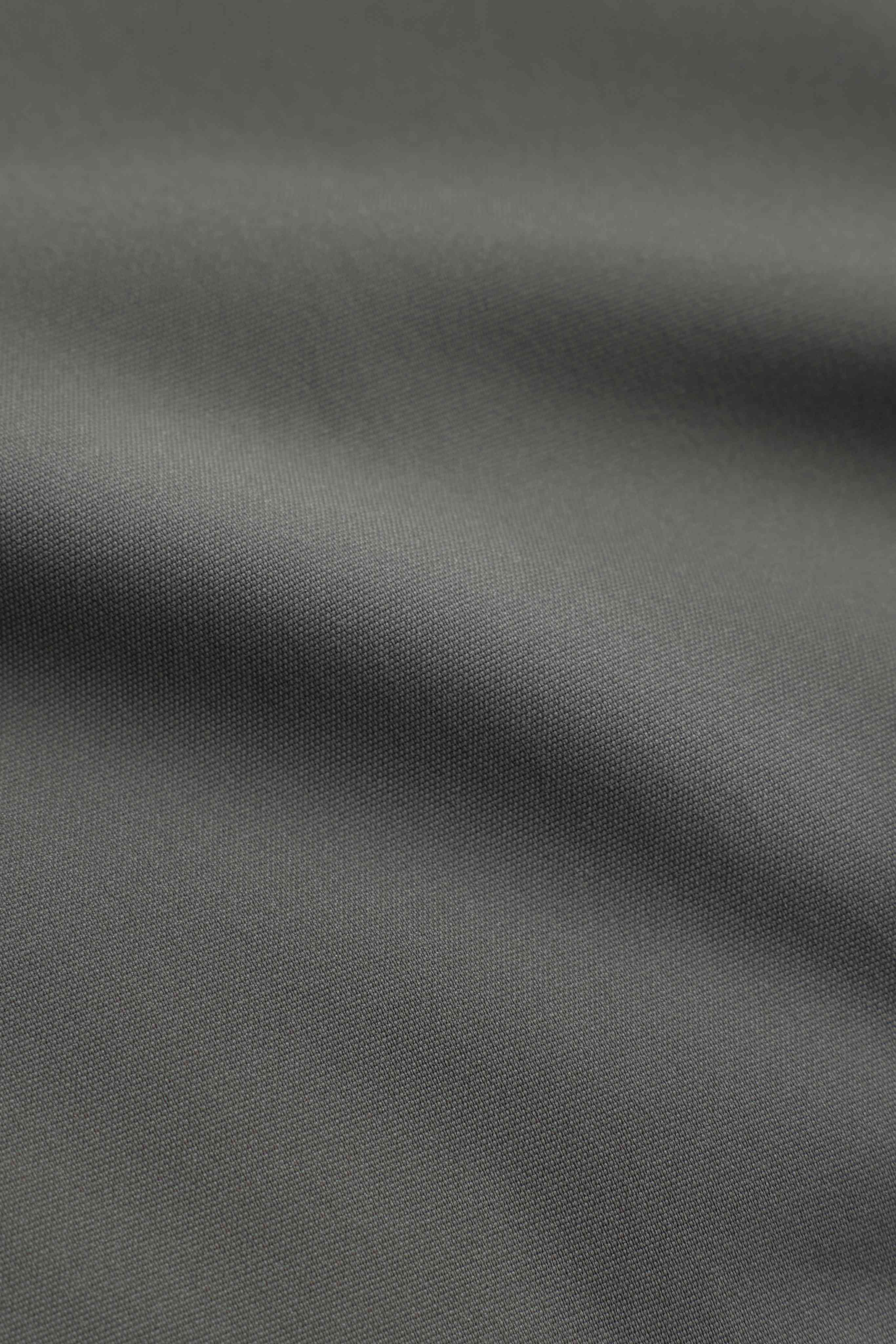 Close-up of the woven khaki outer fabric on the CASPARA Aurora puffer jacket.