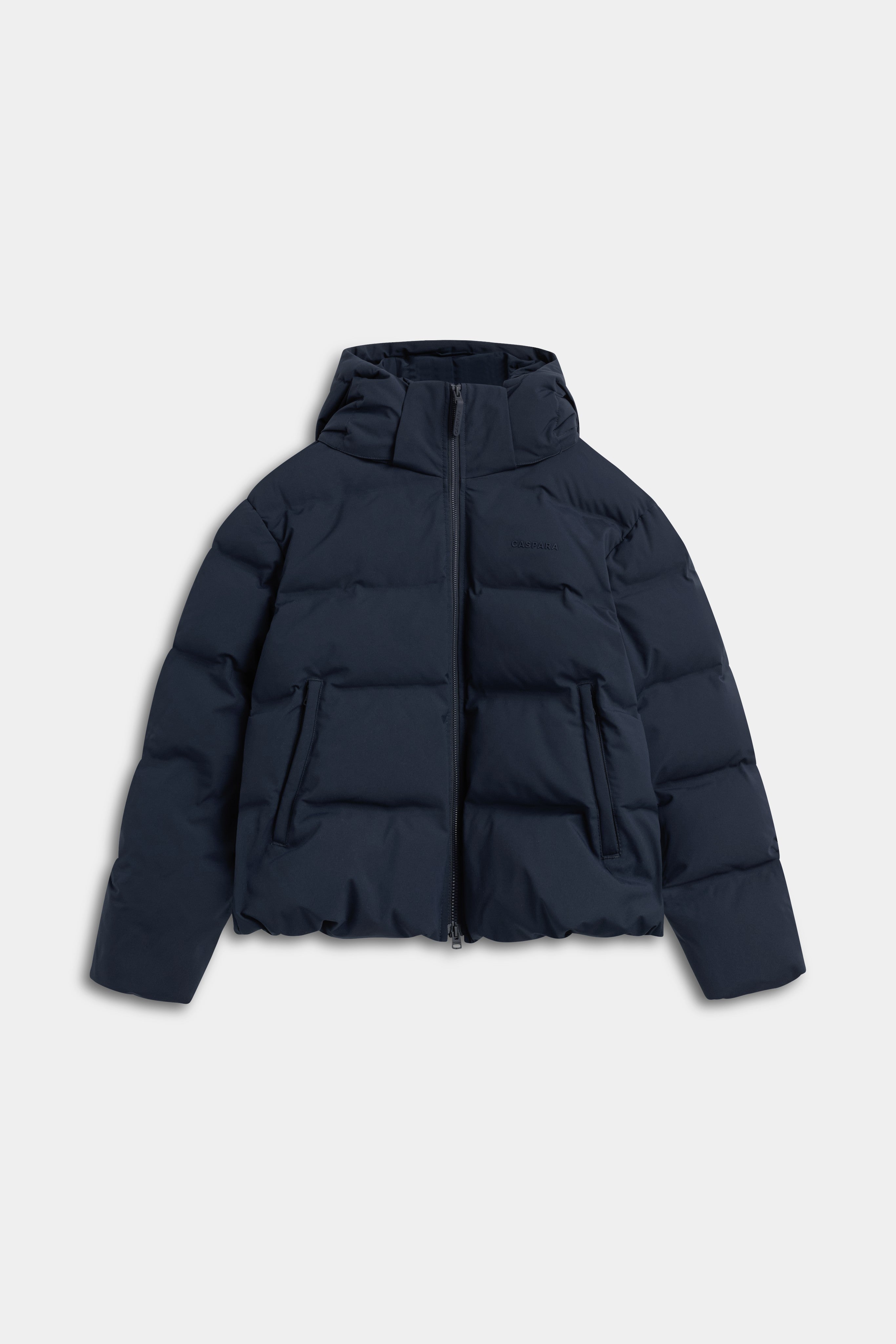 Front view of the navy CASPARA Aurora puffer jacket with a hood.