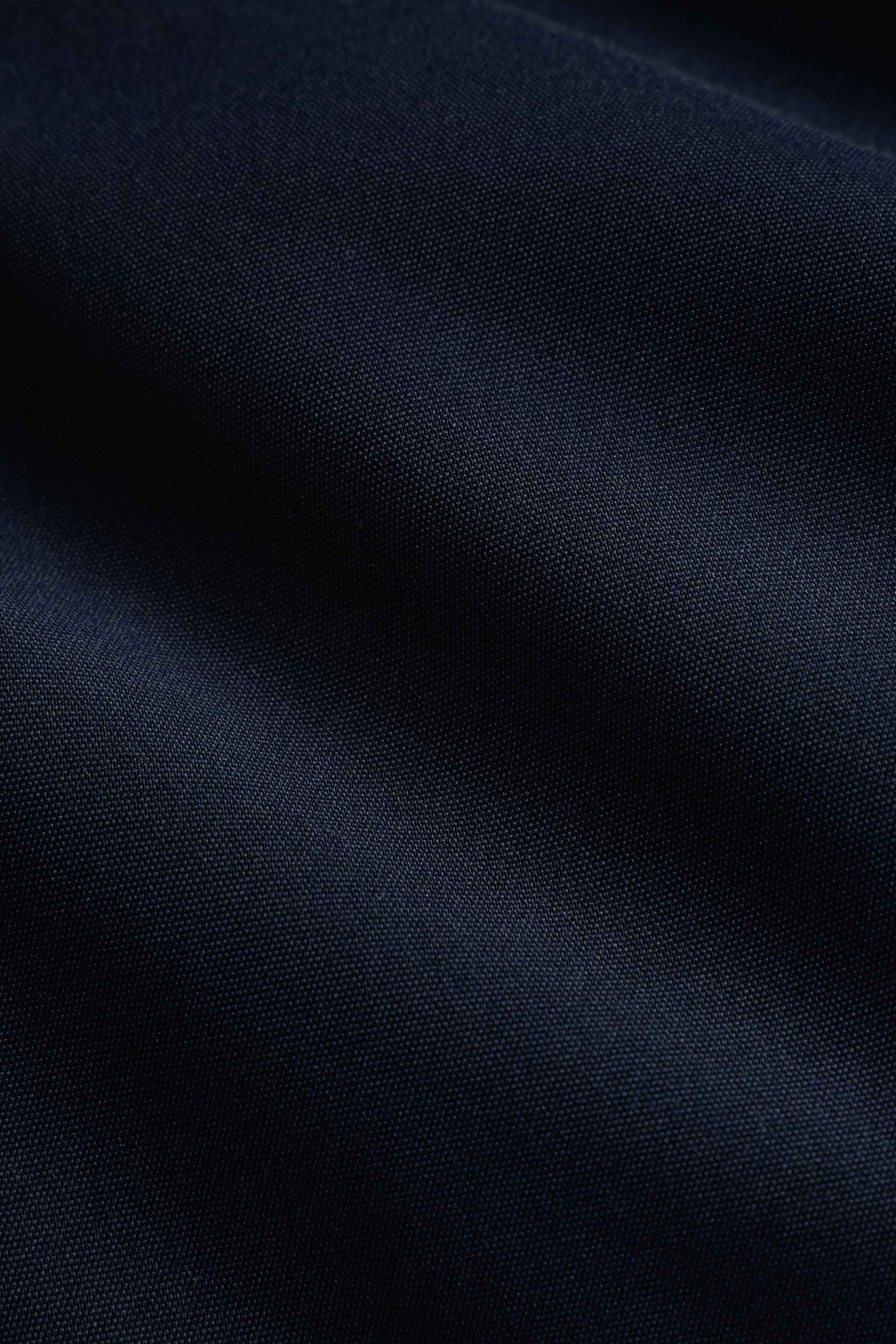 Close-up of the textured navy outer fabric on the CASPARA Aurora puffer jacket.