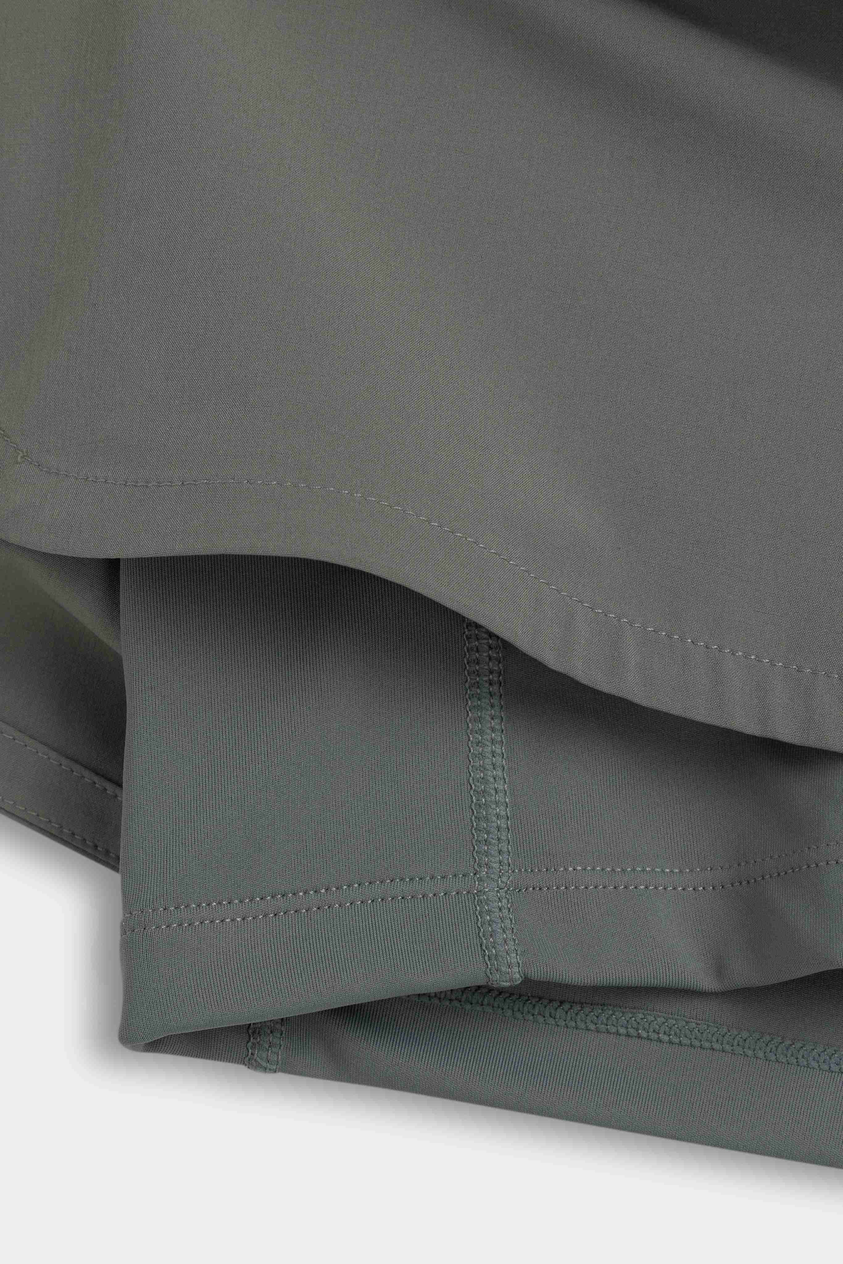 Close-up detail of the inner liner and outer hem on khaki CASPARA Aerluxe shorts.