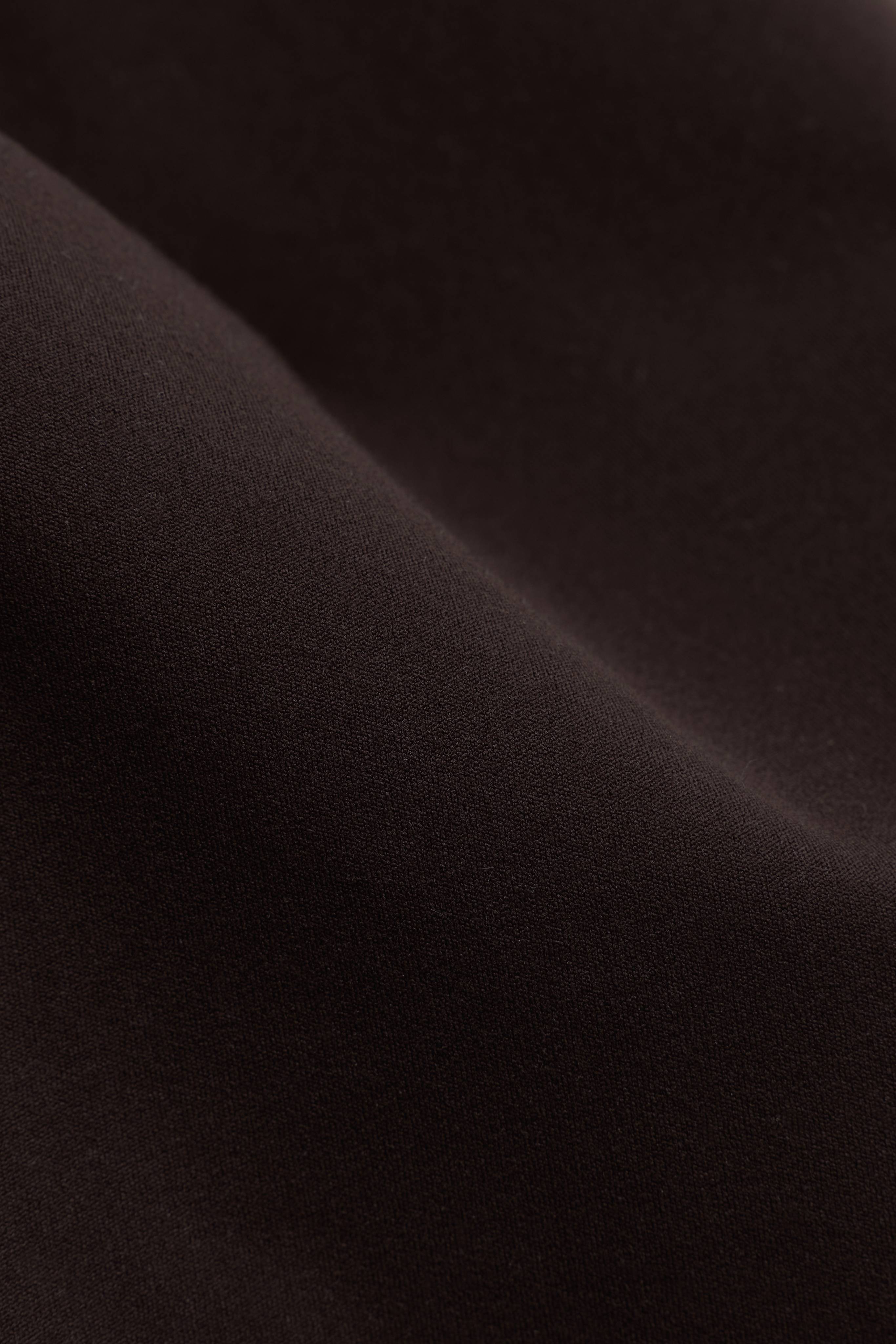 Close-up of the smooth espresso brown stretch fabric on the CASPARA Cloudform Capri.