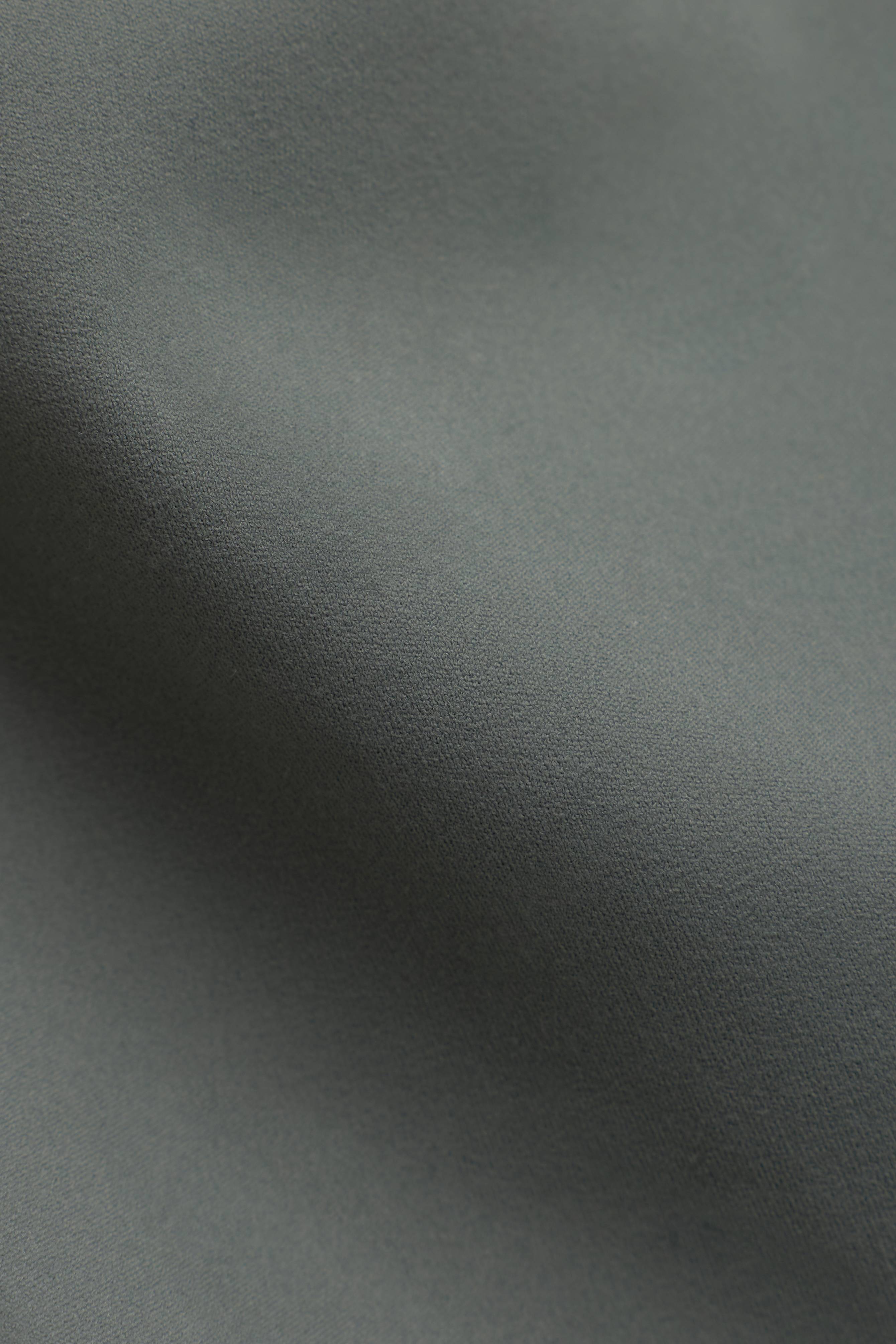 Close-up of the smooth khaki stretch fabric of CASPARA Cloudform capri leggings.