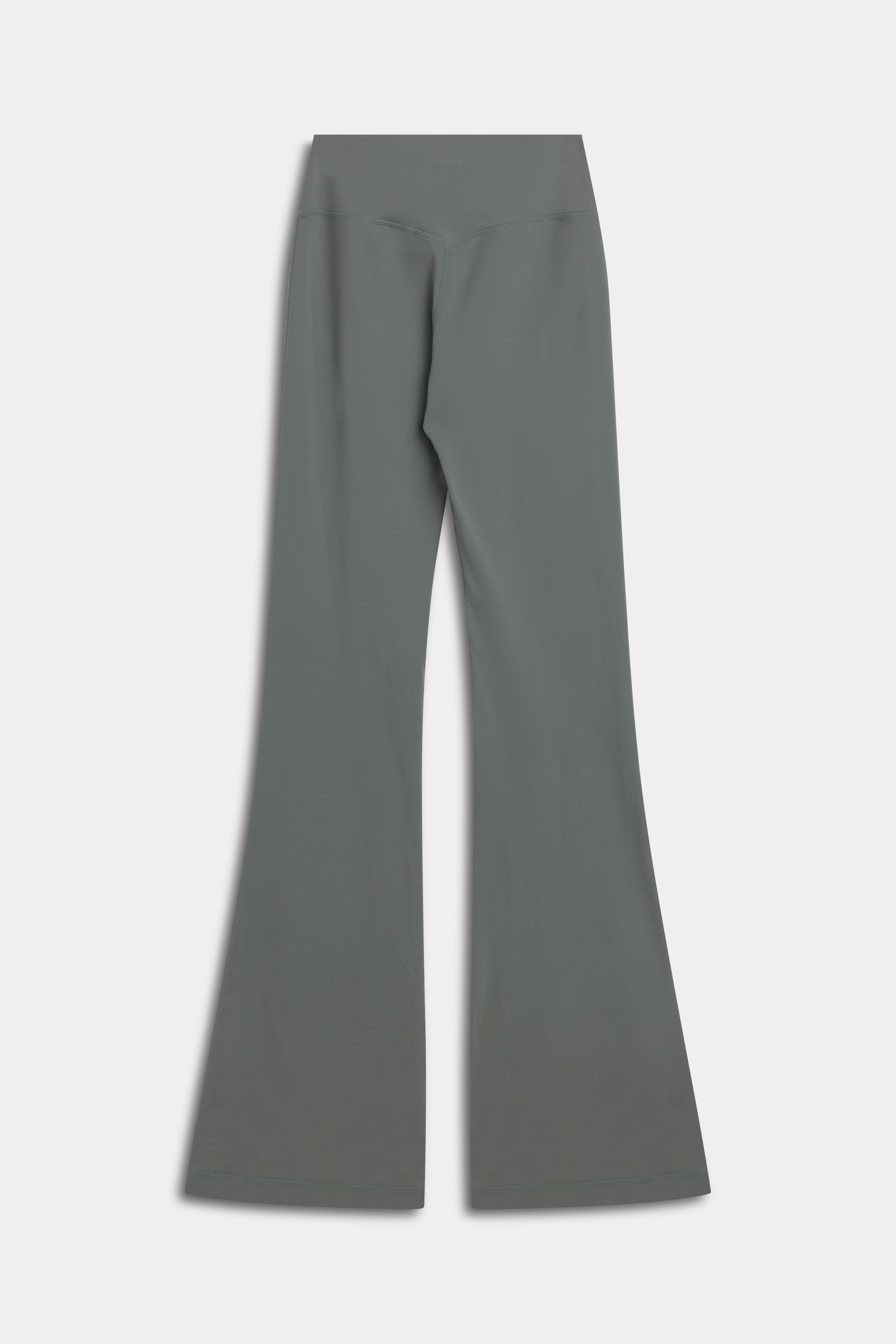 Back view of CASPARA Cloudform flared yoga pants in khaki with a V-shaped back seam.