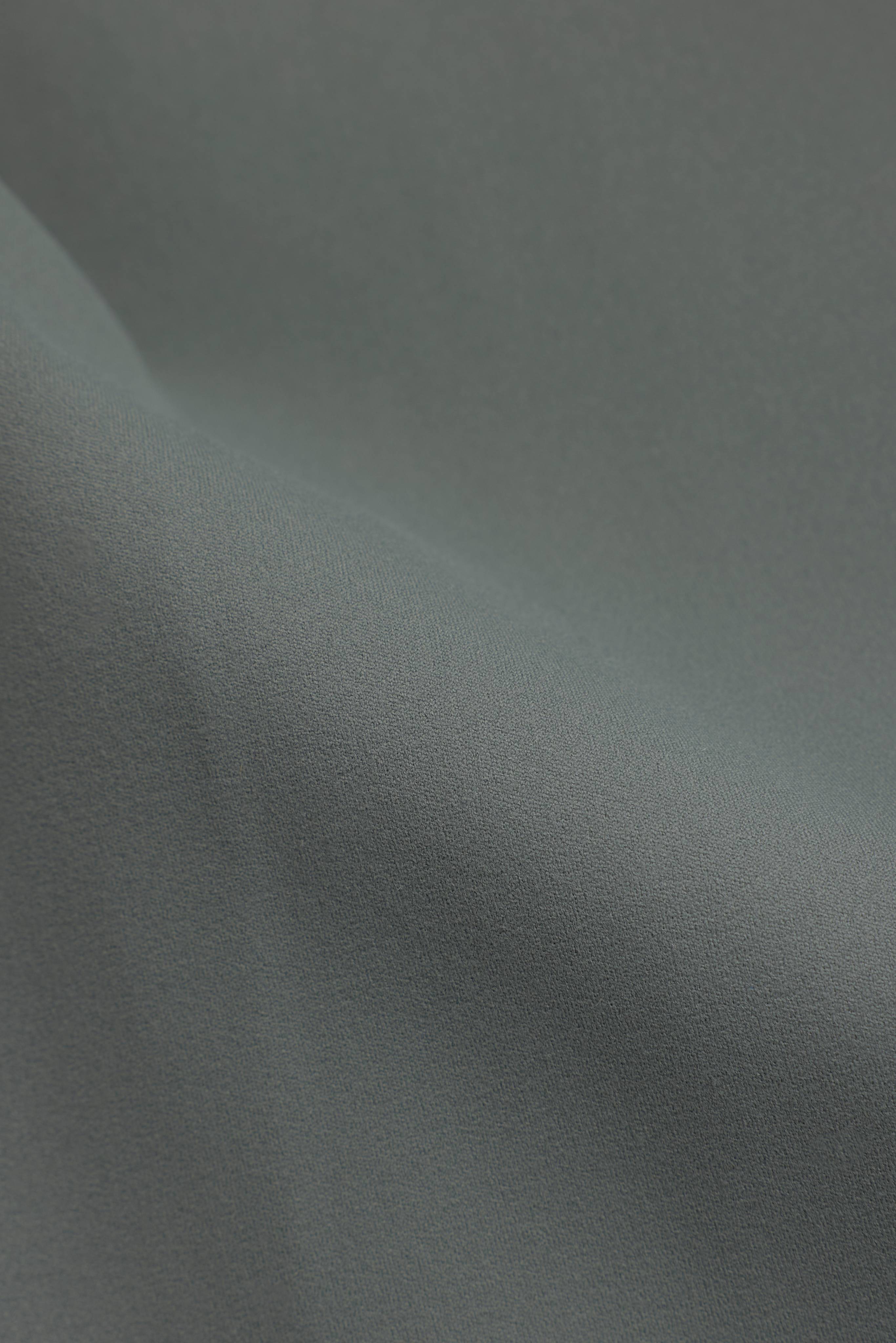Close-up of the soft, matte khaki fabric of the CASPARA Cloudform yoga pant.
