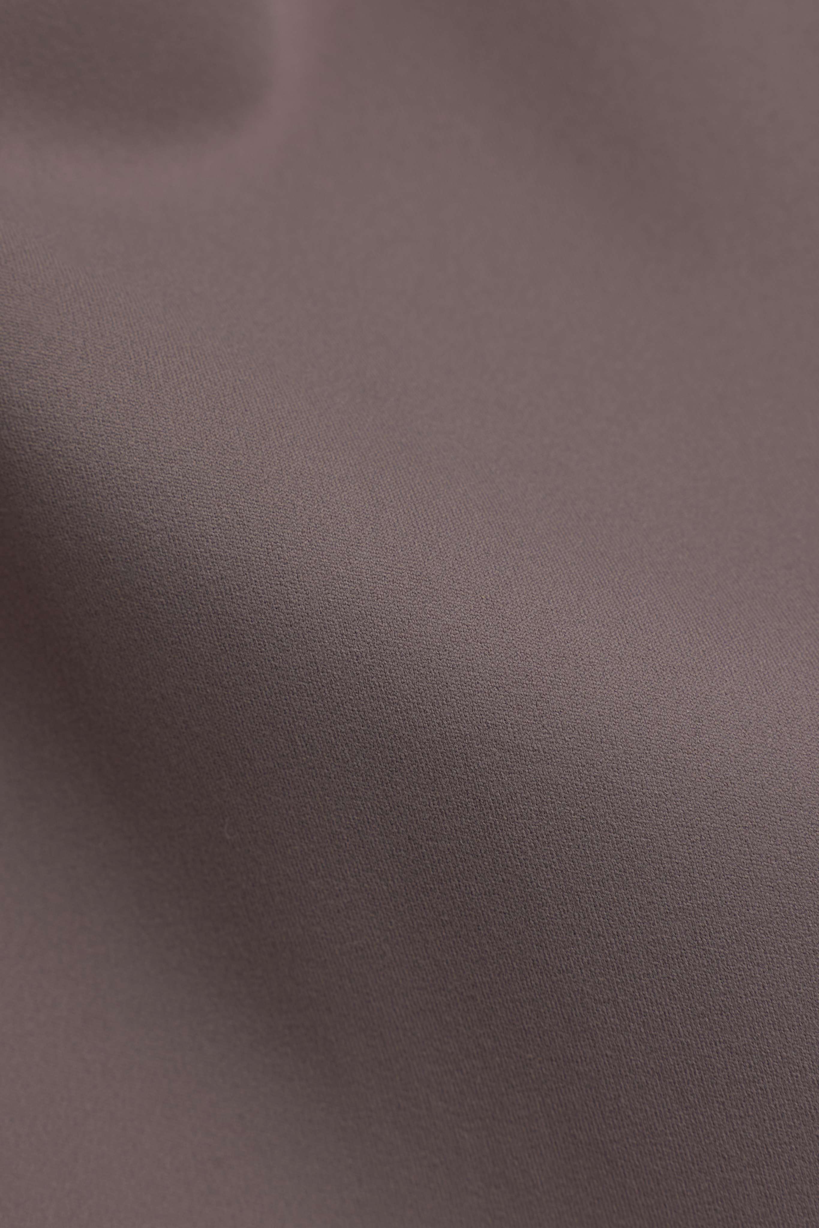 Close-up of walnut brown CASPARA Cloudform fabric showing its smooth, matte texture.