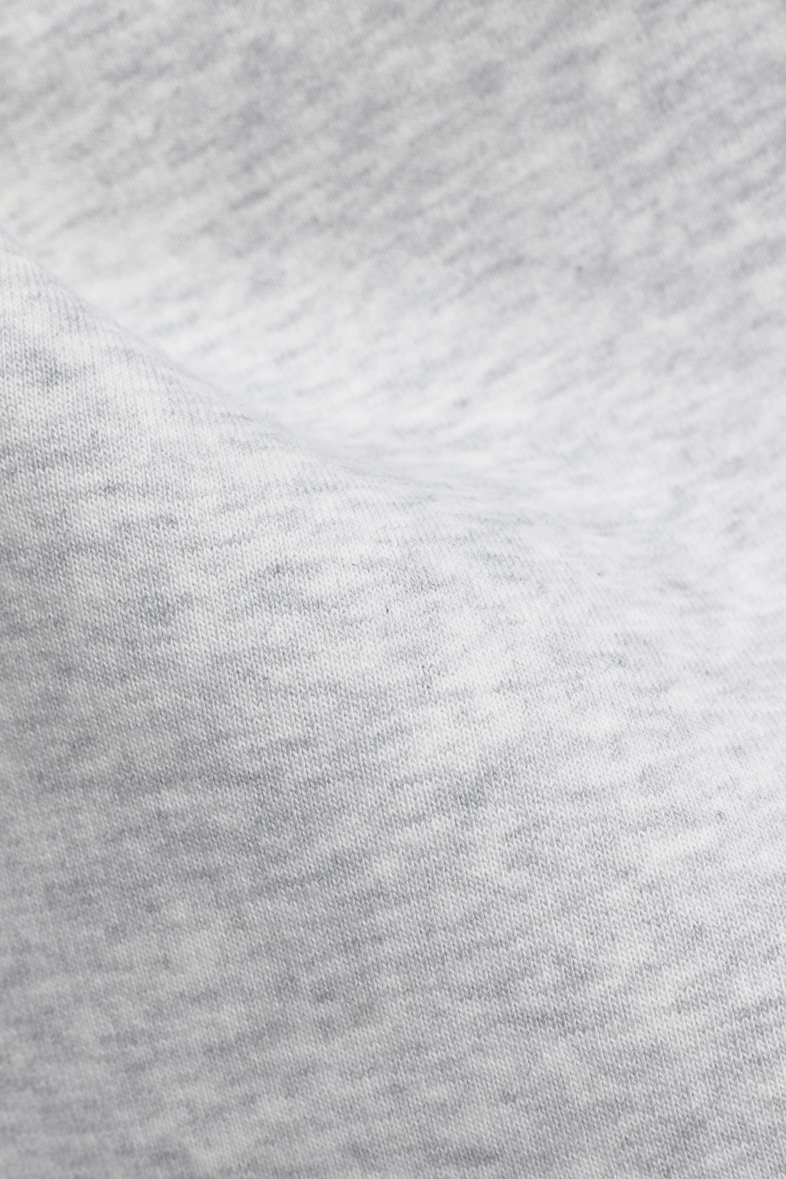 Close-up of soft grey melange fabric texture on CASPARA CS SL sweatpants.