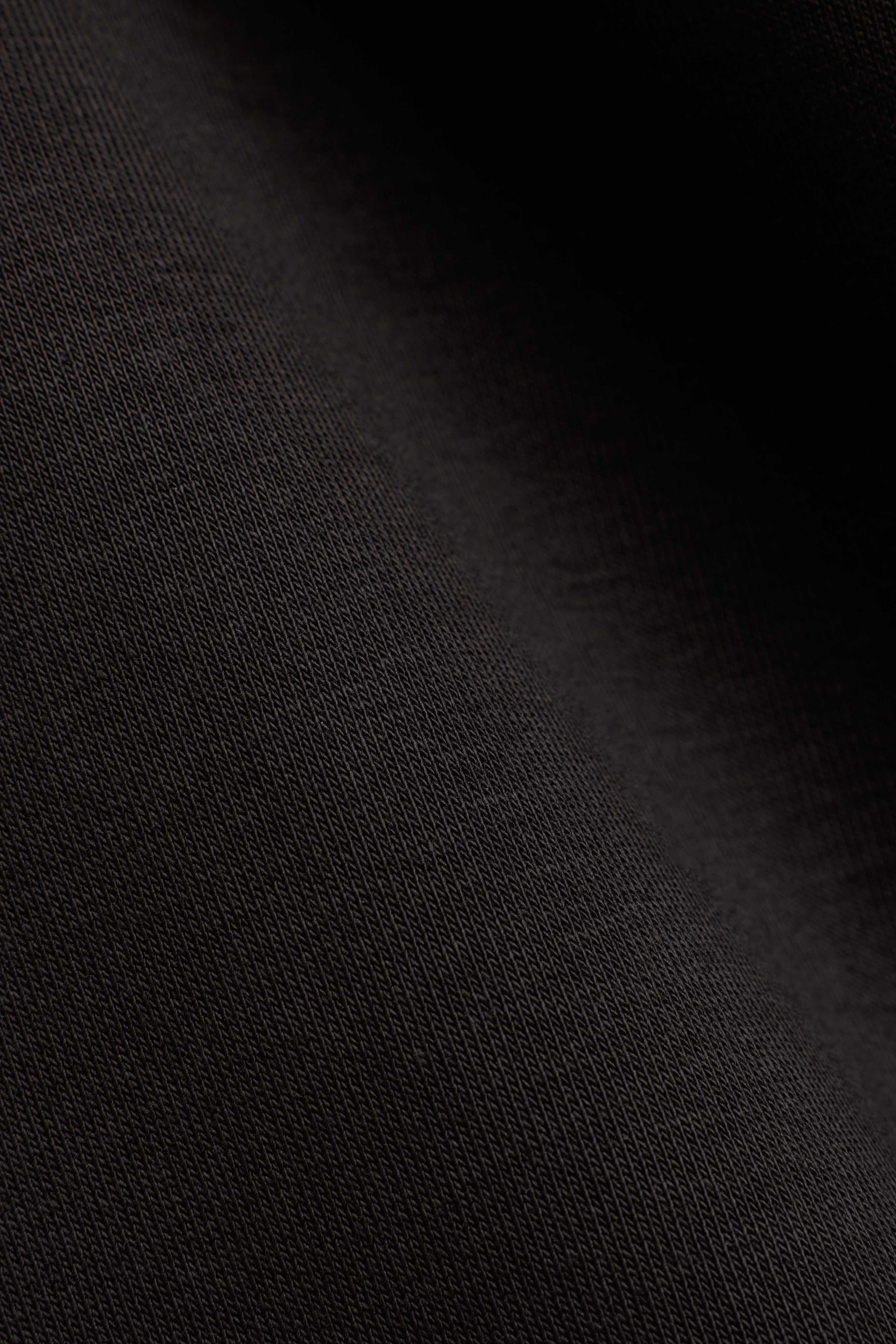 Close-up of the espresso brown fabric texture on CASPARA CS sweatpants.