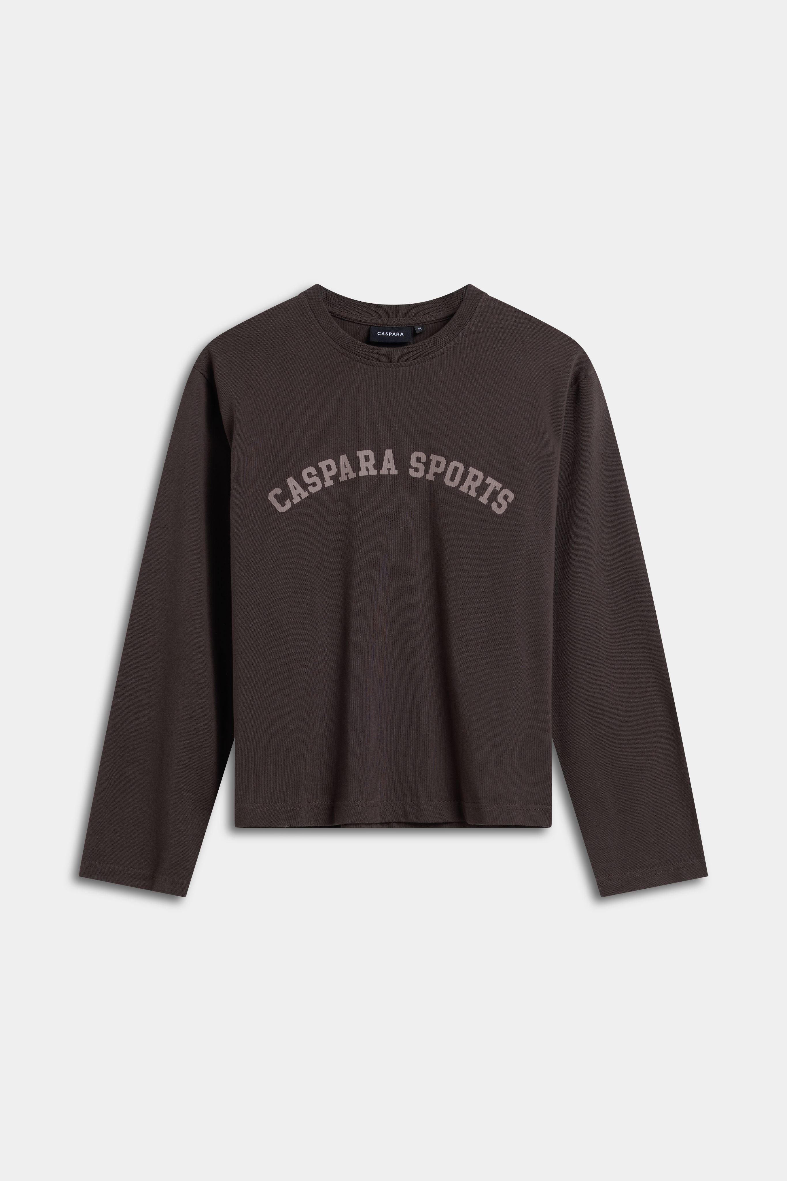 Espresso CASPARA CS Signature long sleeve shirt with arched CASPARA SPORTS lettering on the front.