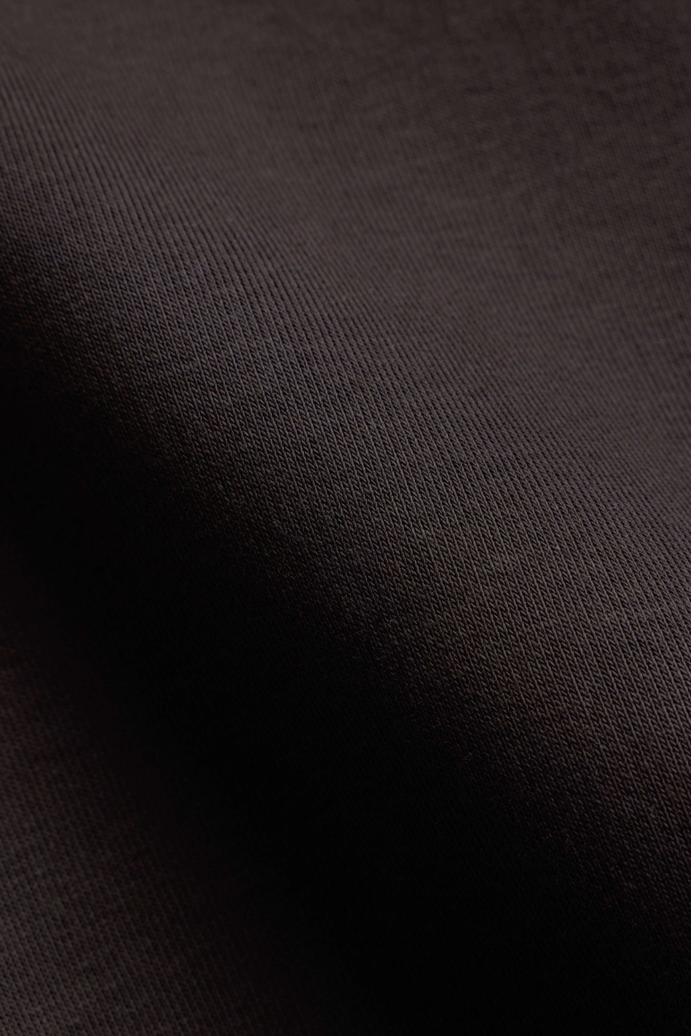 Close-up of the espresso brown fabric on a CASPARA CS crewneck sweatshirt.
