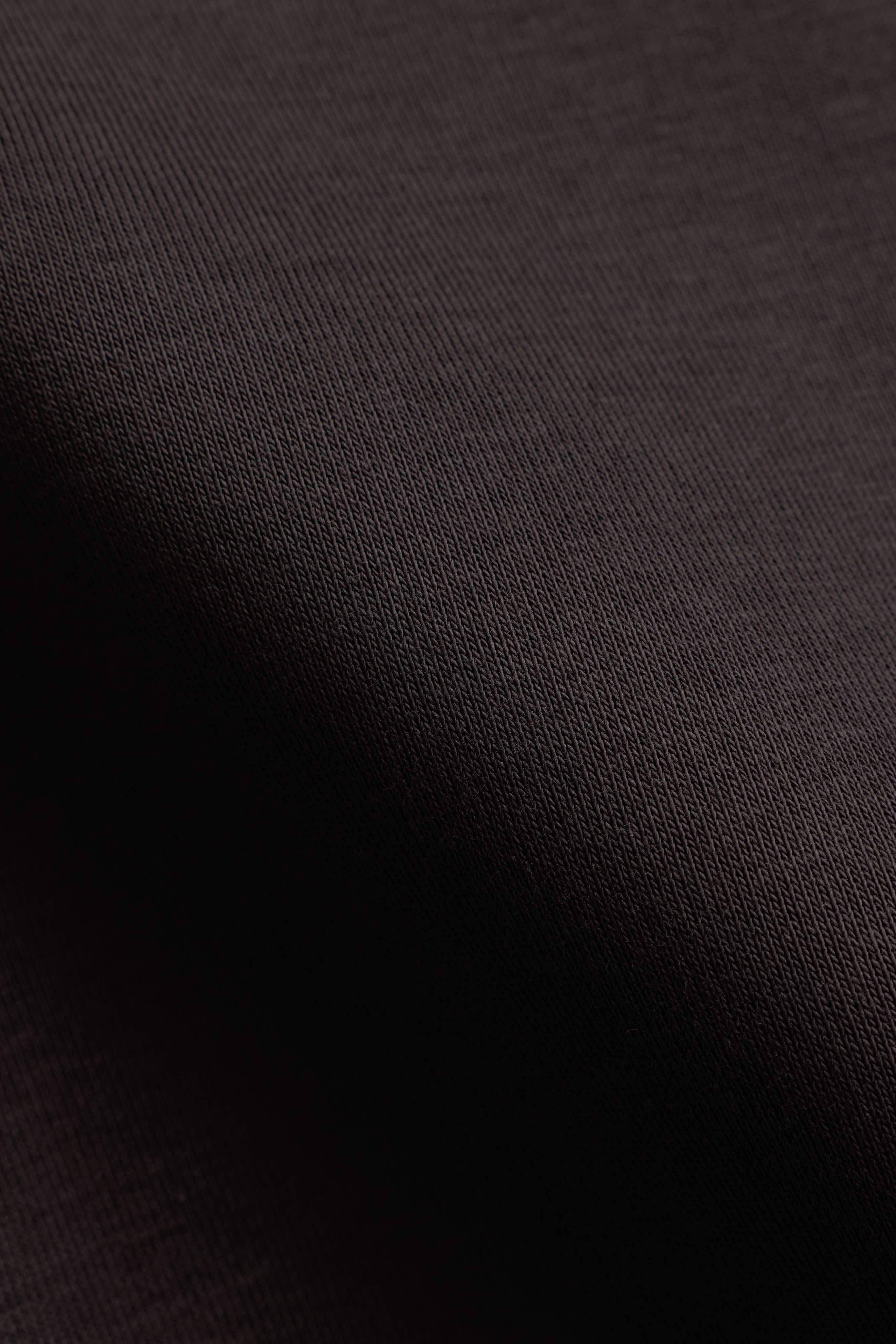 Close-up of the espresso brown knit fabric texture on a CASPARA CS rugby shirt.
