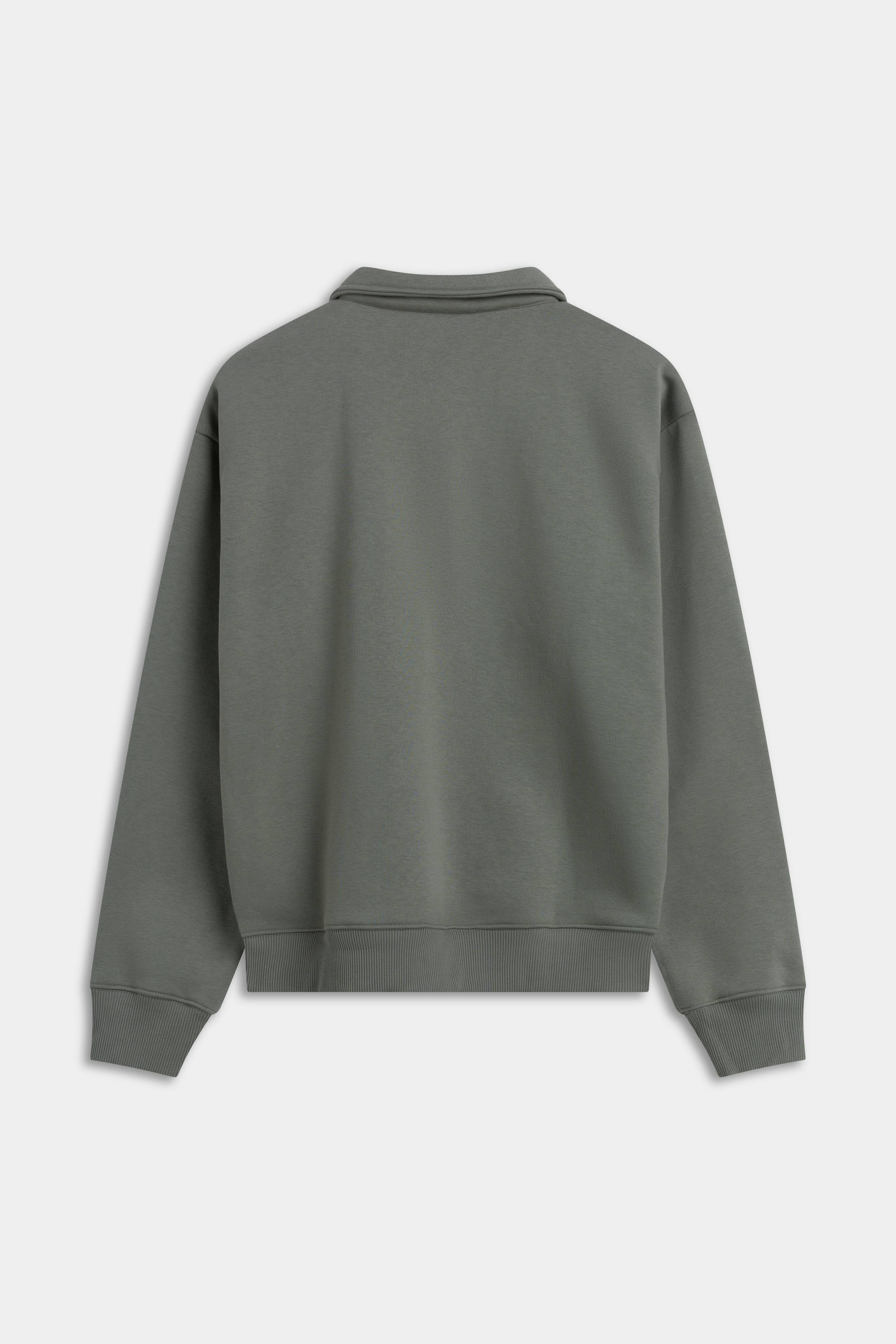 Back view of the khaki CASPARA CS rugby shirt against a light grey background.