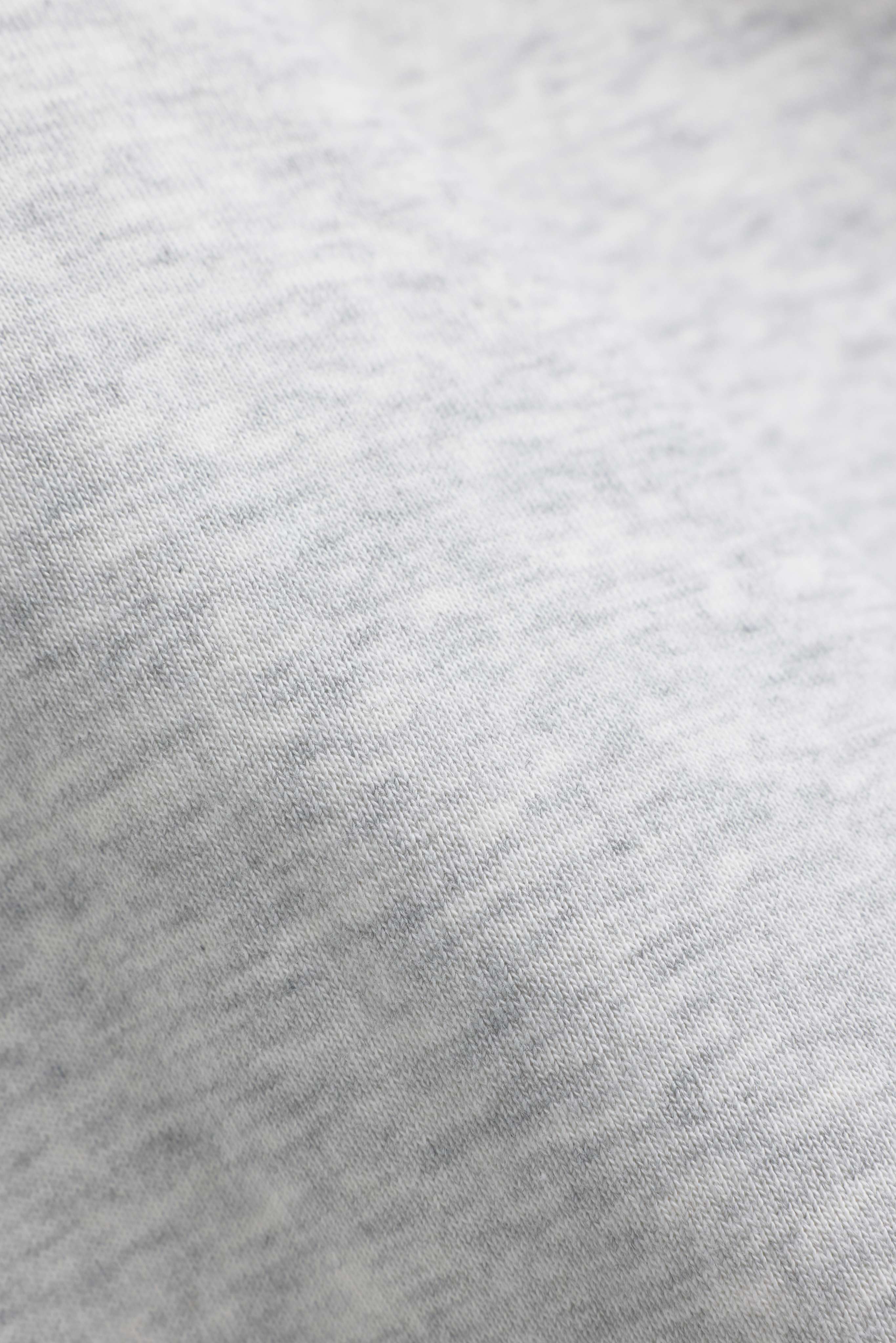 Close-up of the soft grey melange knit fabric of a CASPARA CS rugby shirt.