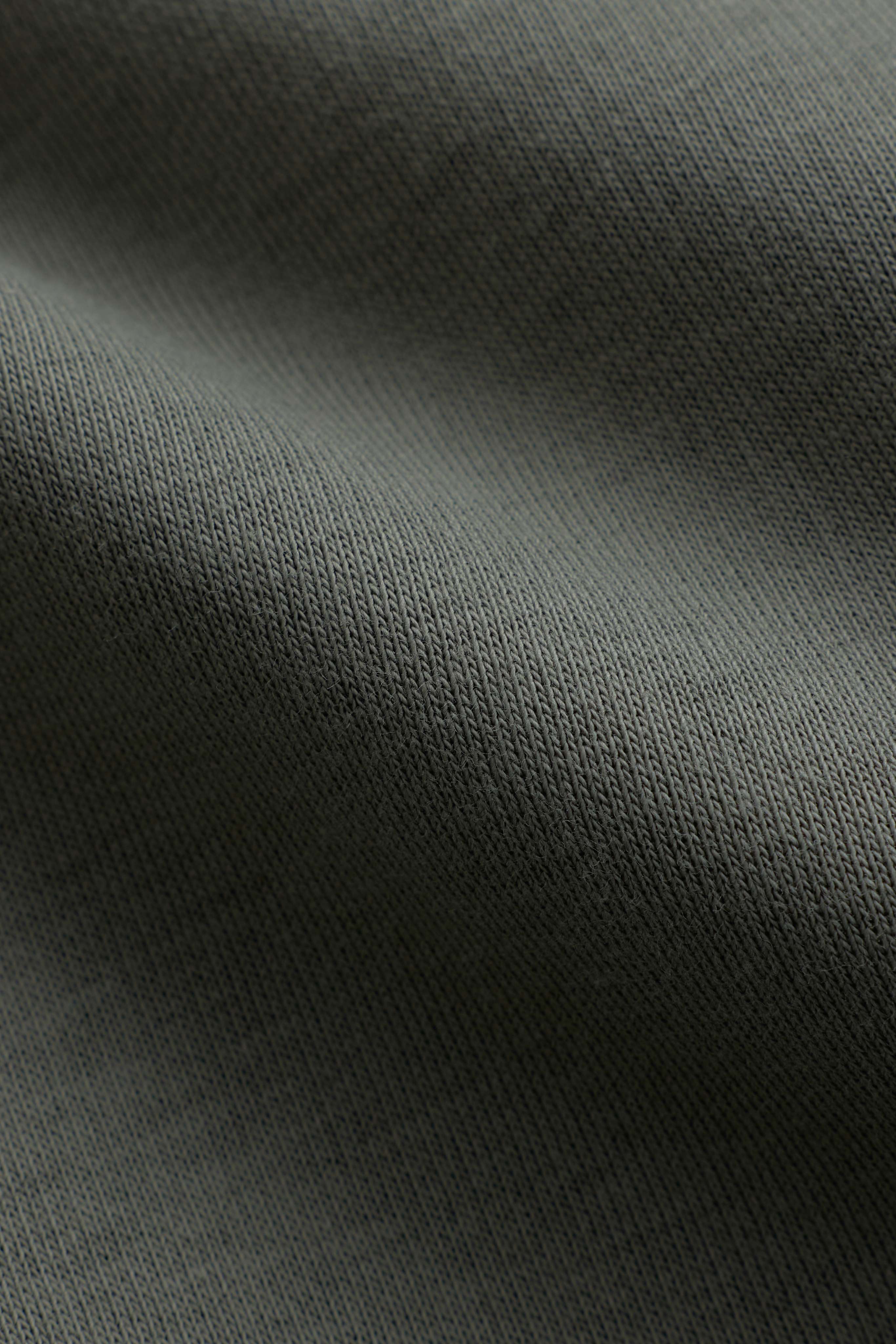 Close-up of the soft khaki fabric texture on the CASPARA CS Hoodie.