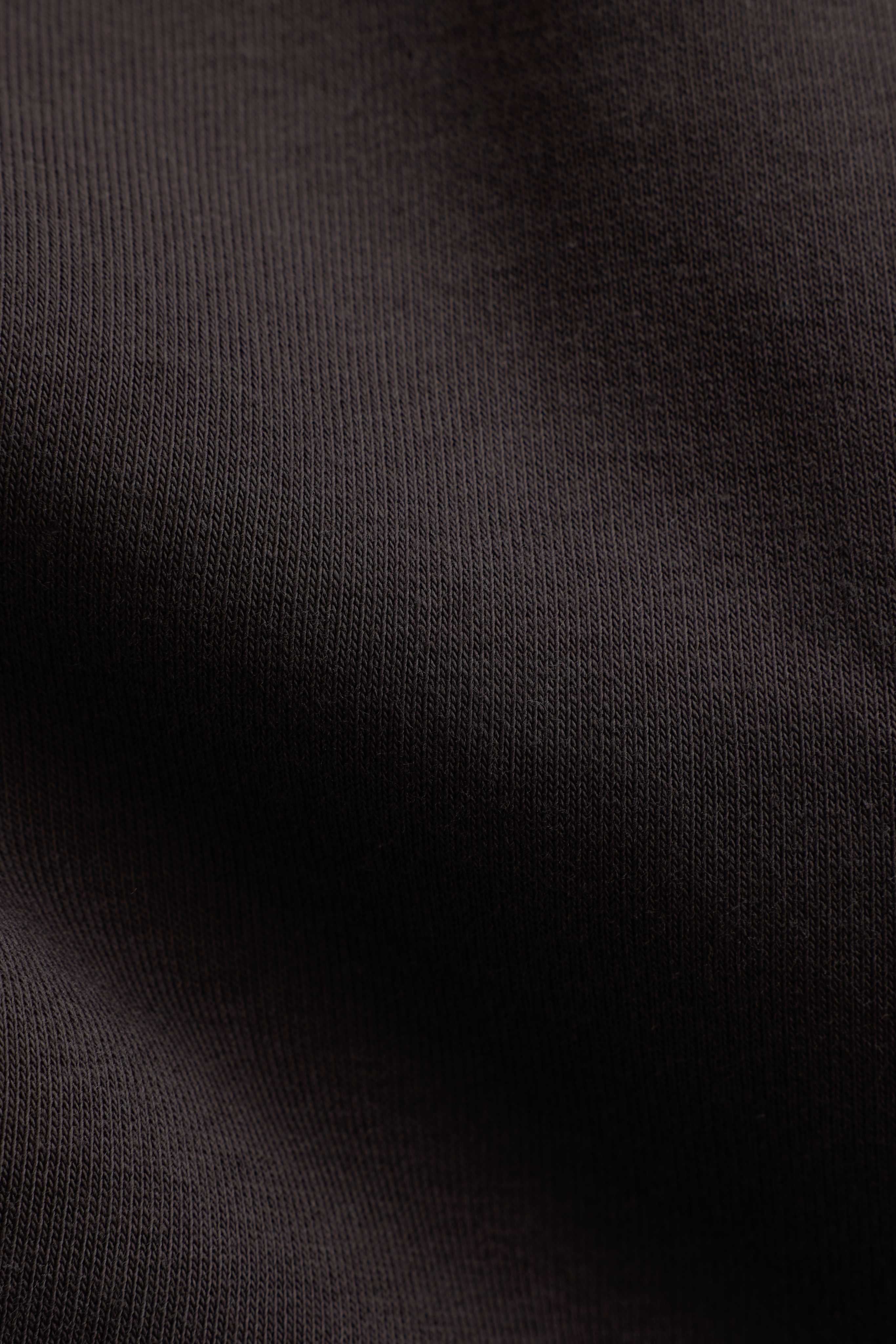 Close-up of the espresso brown fabric texture on the CASPARA CS hoodie.