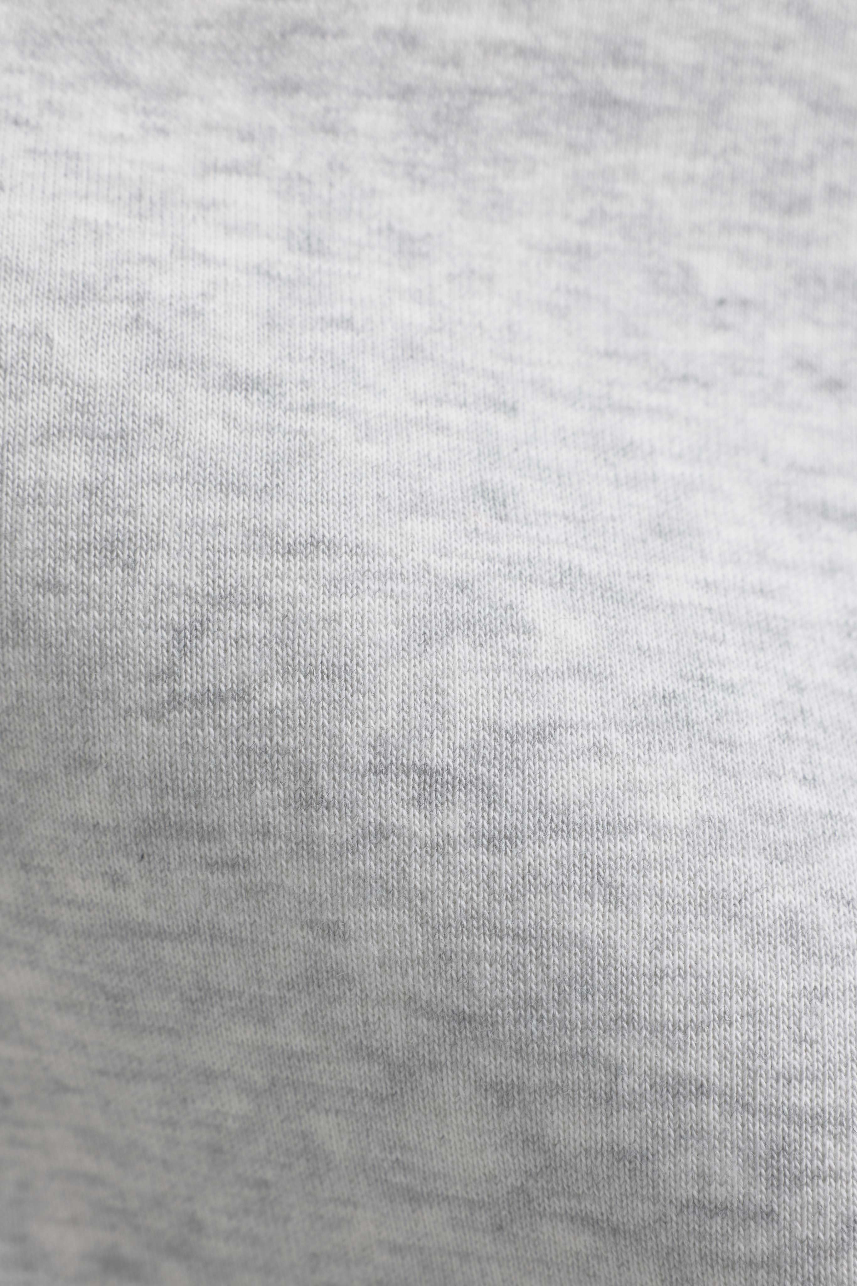 Close-up of the grey melange fabric texture on the CASPARA CS hoodie.