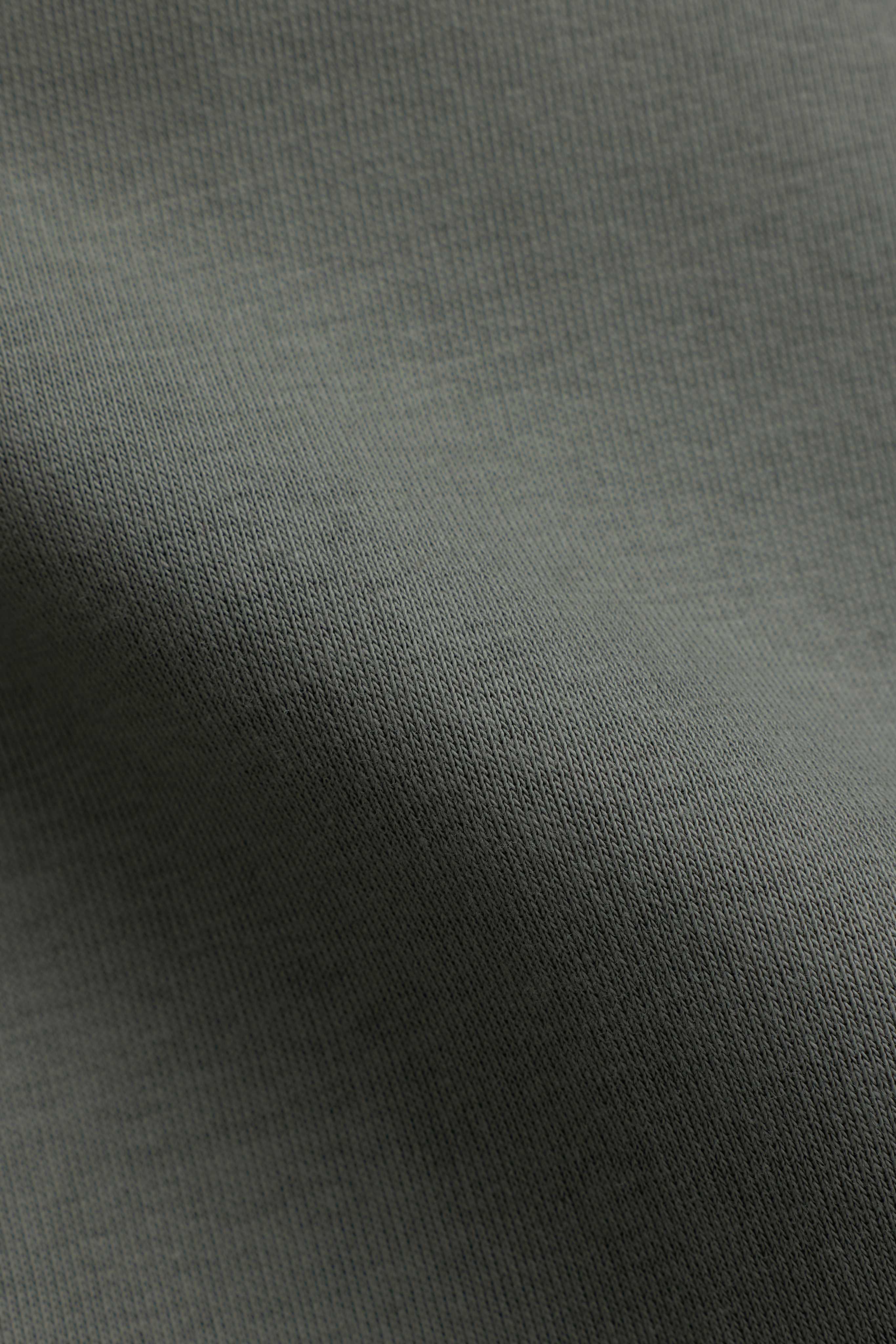 Close-up of the soft khaki knit fabric on the CASPARA CS hoodie.
