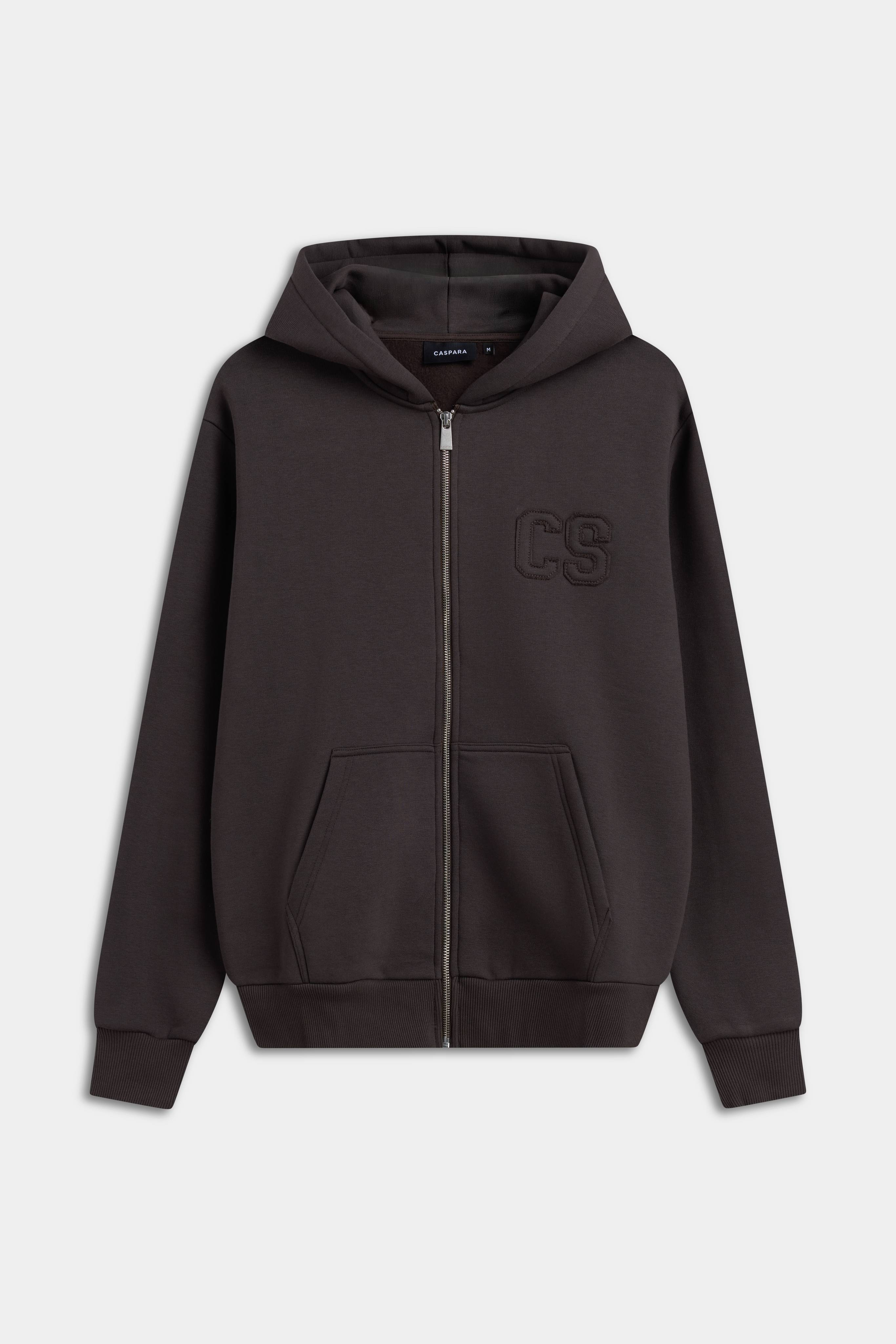 CASPARA CS zip hoodie in espresso brown with a silver front zipper and tonal chest logo.