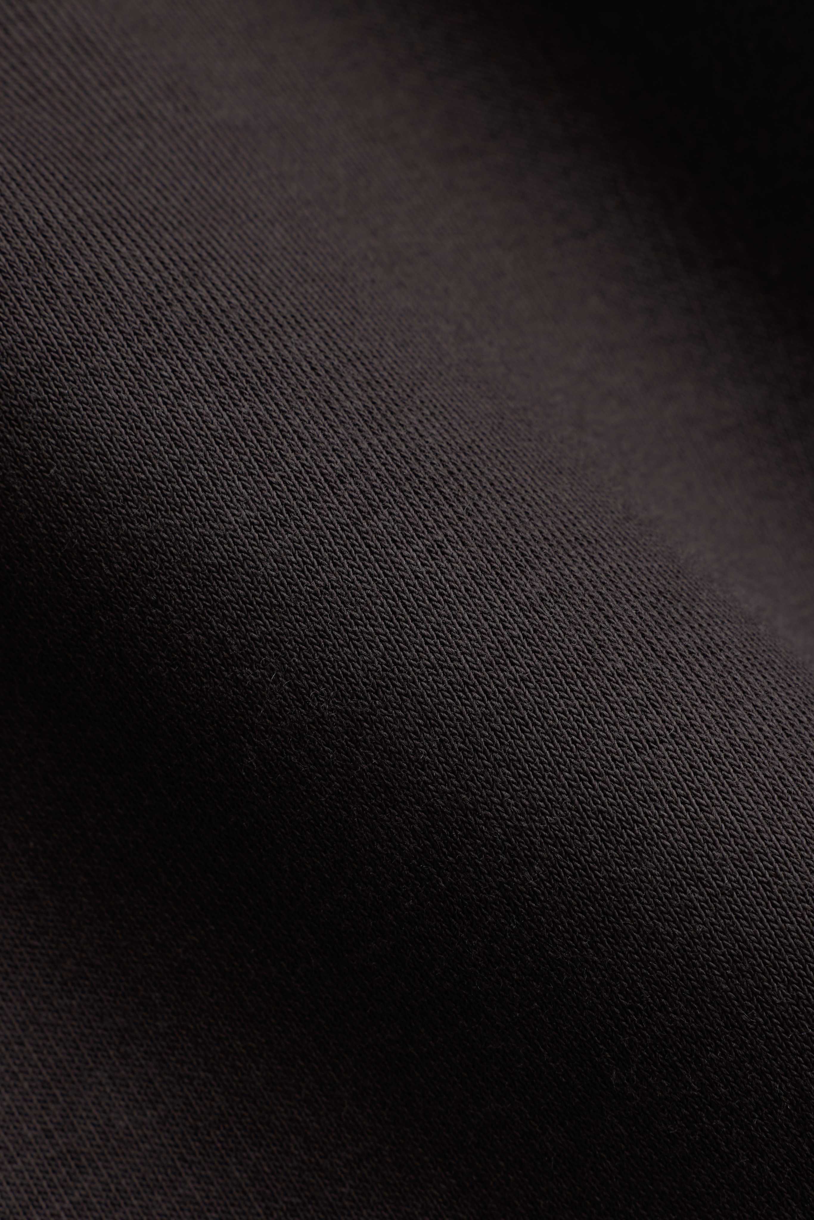 Close-up of the espresso brown fabric texture on a CASPARA CS Zip Hoodie.
