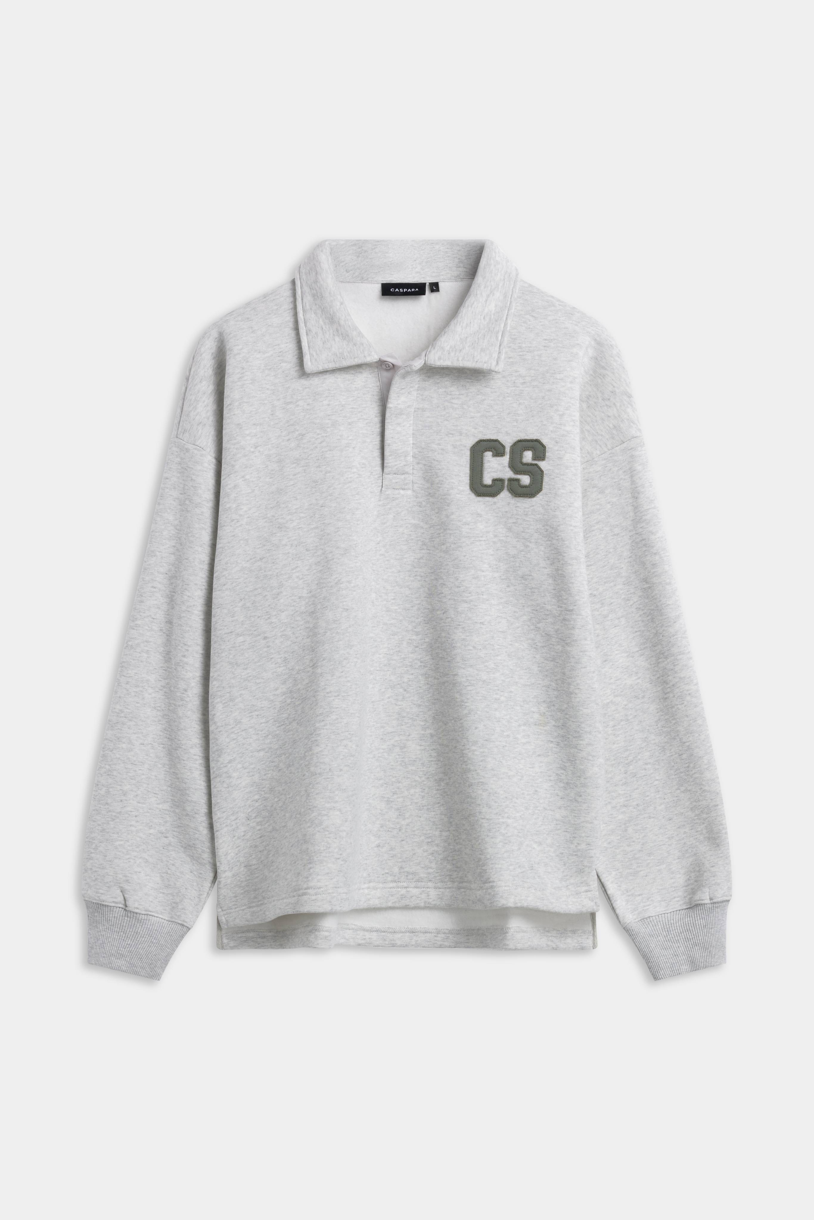 Front view of the CASPARA CS rugby shirt in grey melange with a khaki CS chest patch.