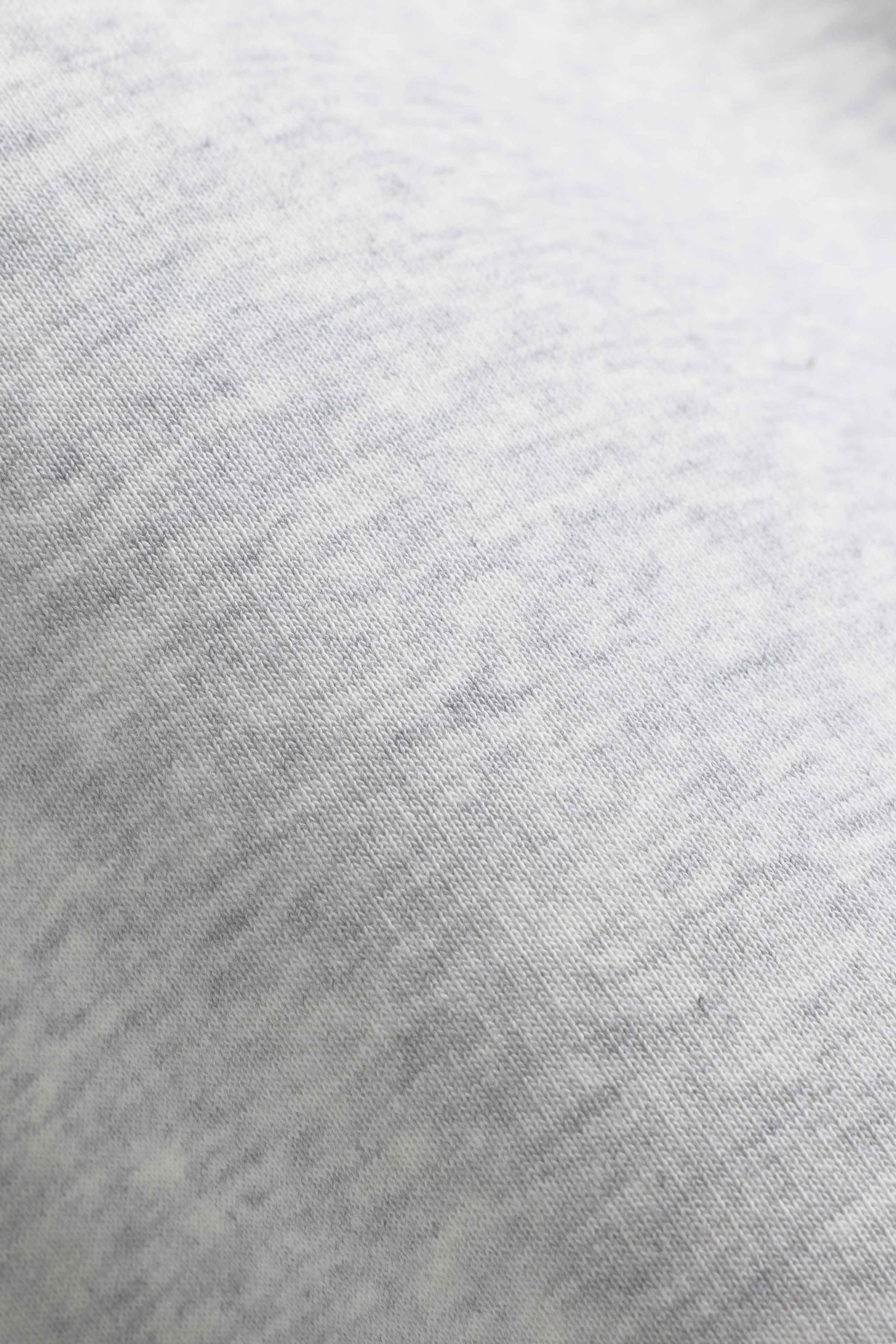 Close-up of the textured grey melange fabric on a CASPARA CS rugby shirt.