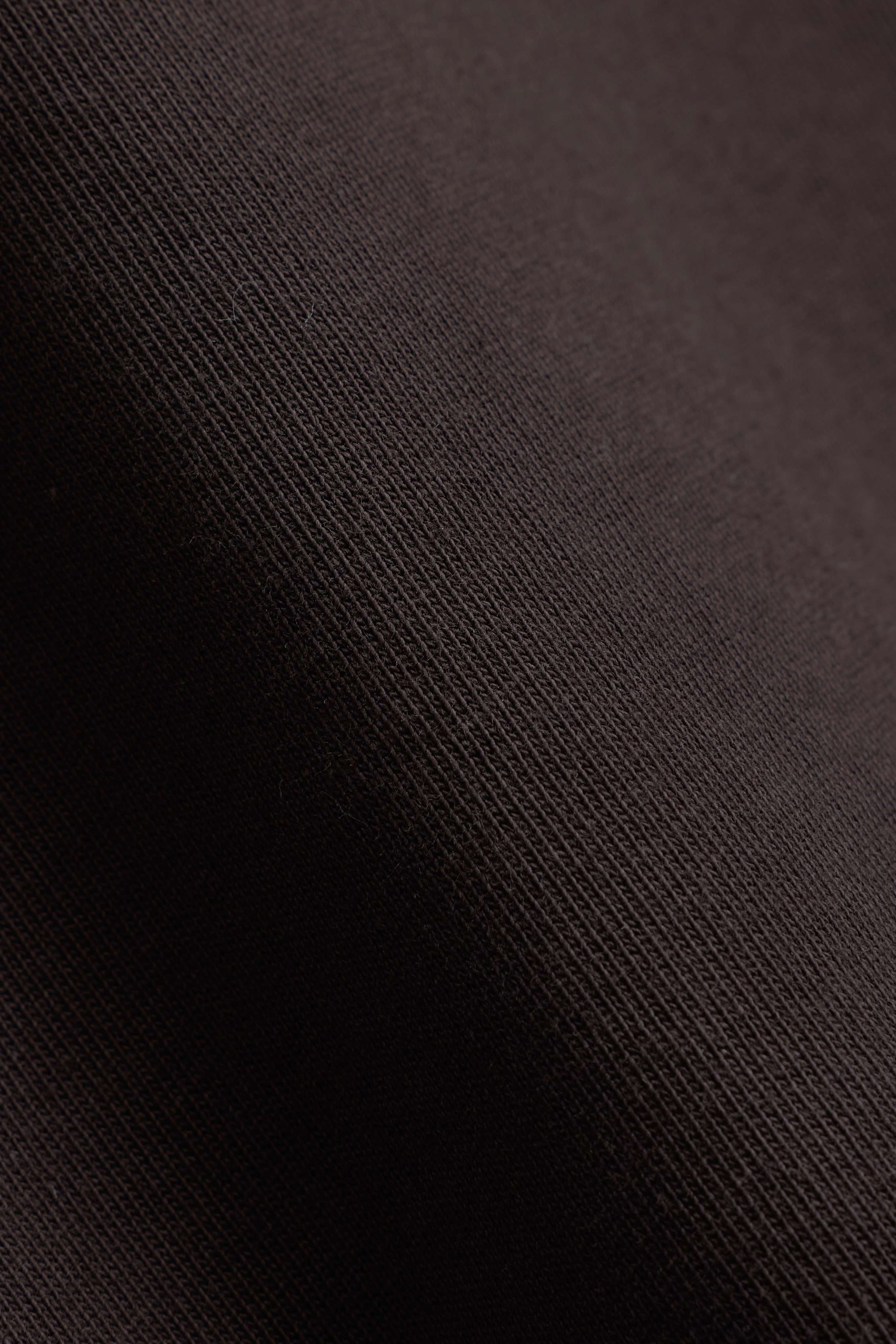 Close-up of the espresso brown cotton fabric on the CASPARA CS Signature long sleeve.