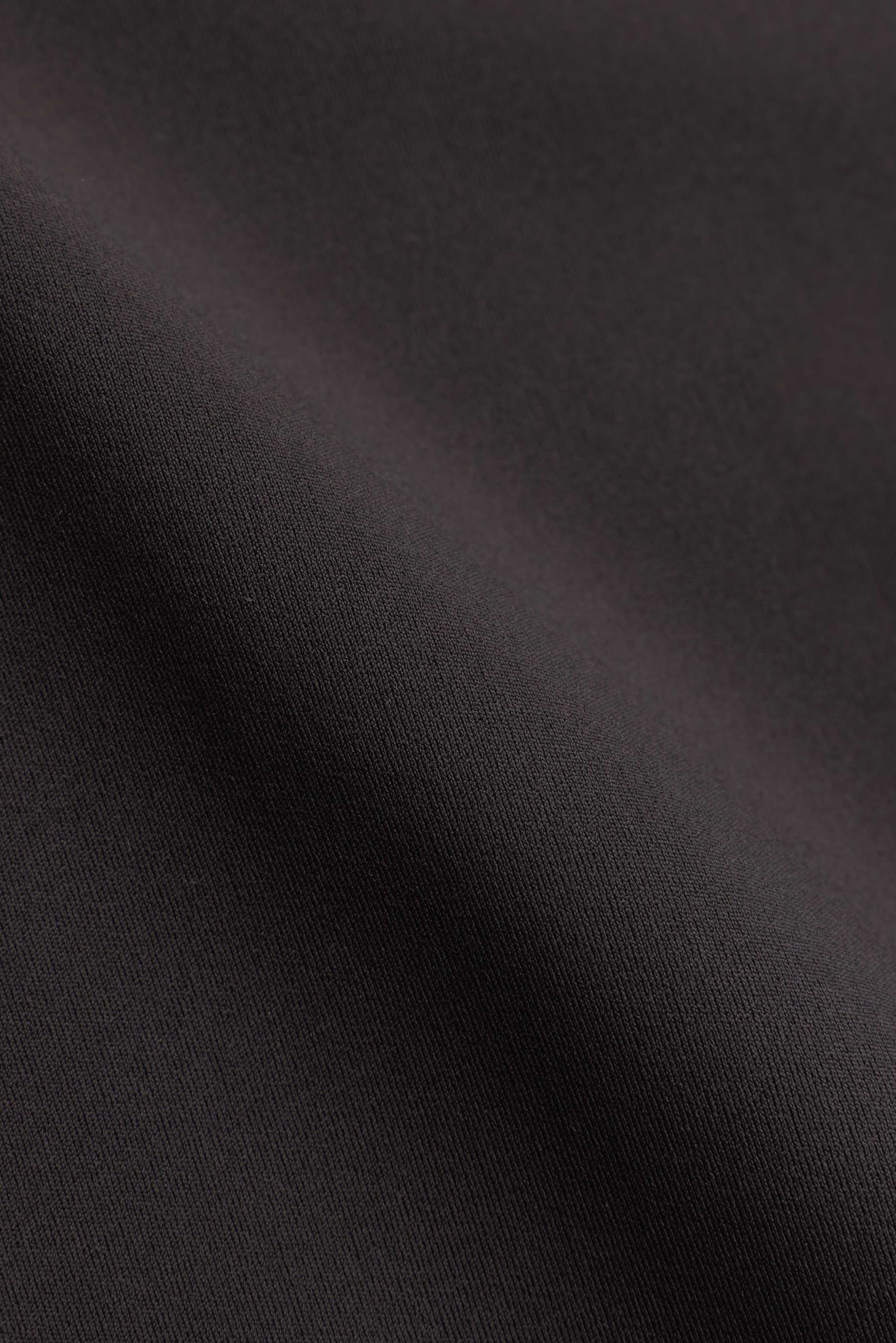 Close-up of the espresso brown fabric texture on the CASPARA Prime Core Half Zip.