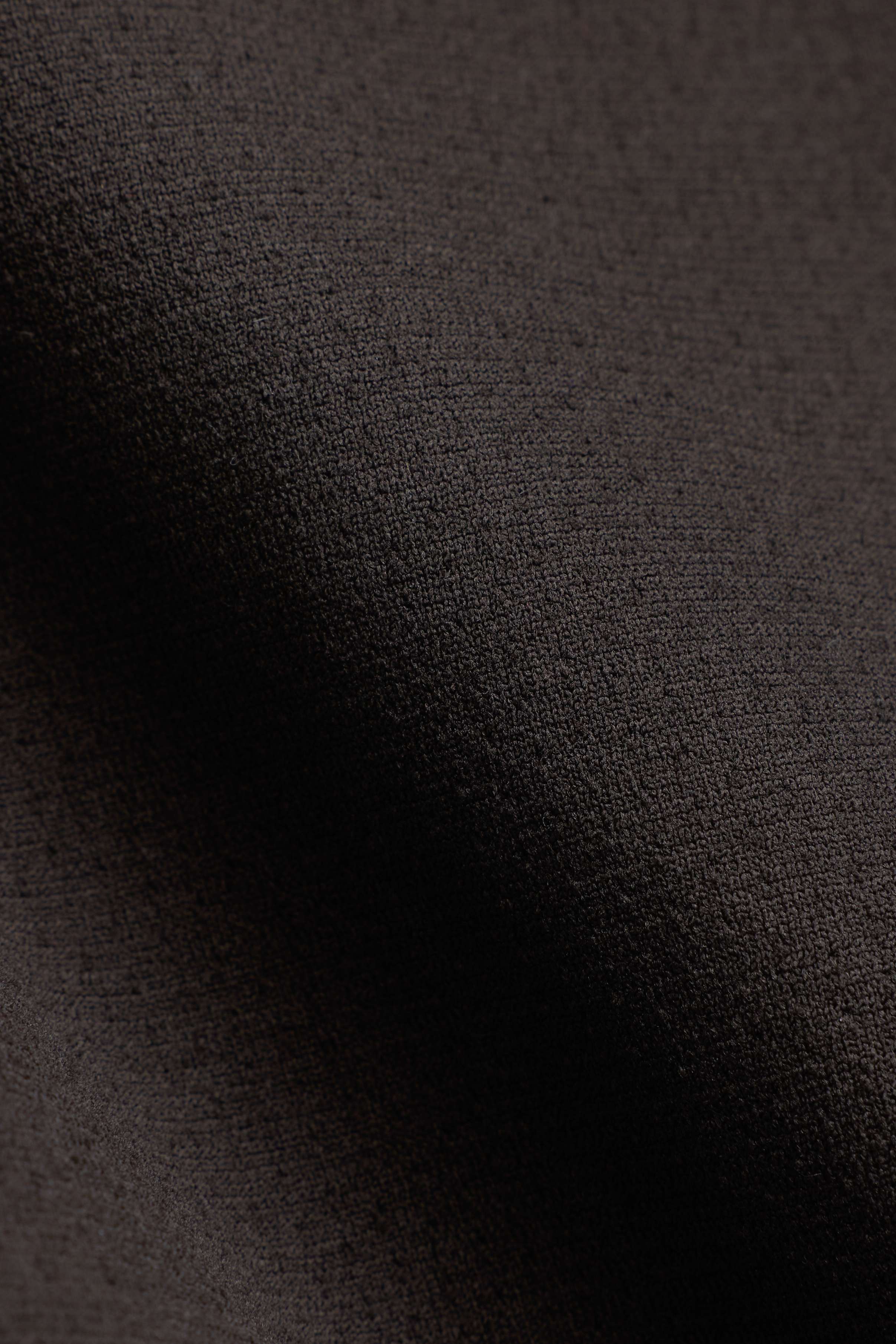 Close-up view of the espresso brown fabric texture on the CASPARA Seamlite tee.