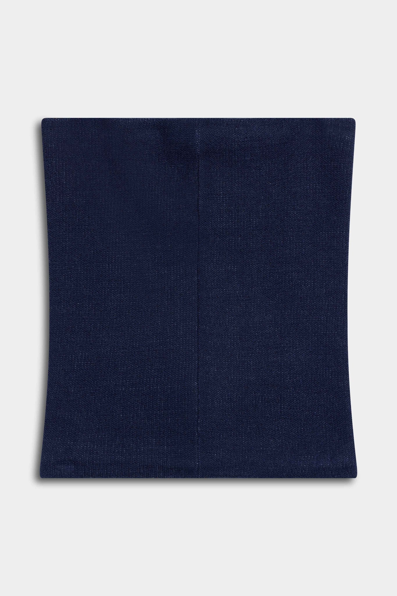 CASPARA Classic Neckwarmer in navy knit laid flat against a light grey background.