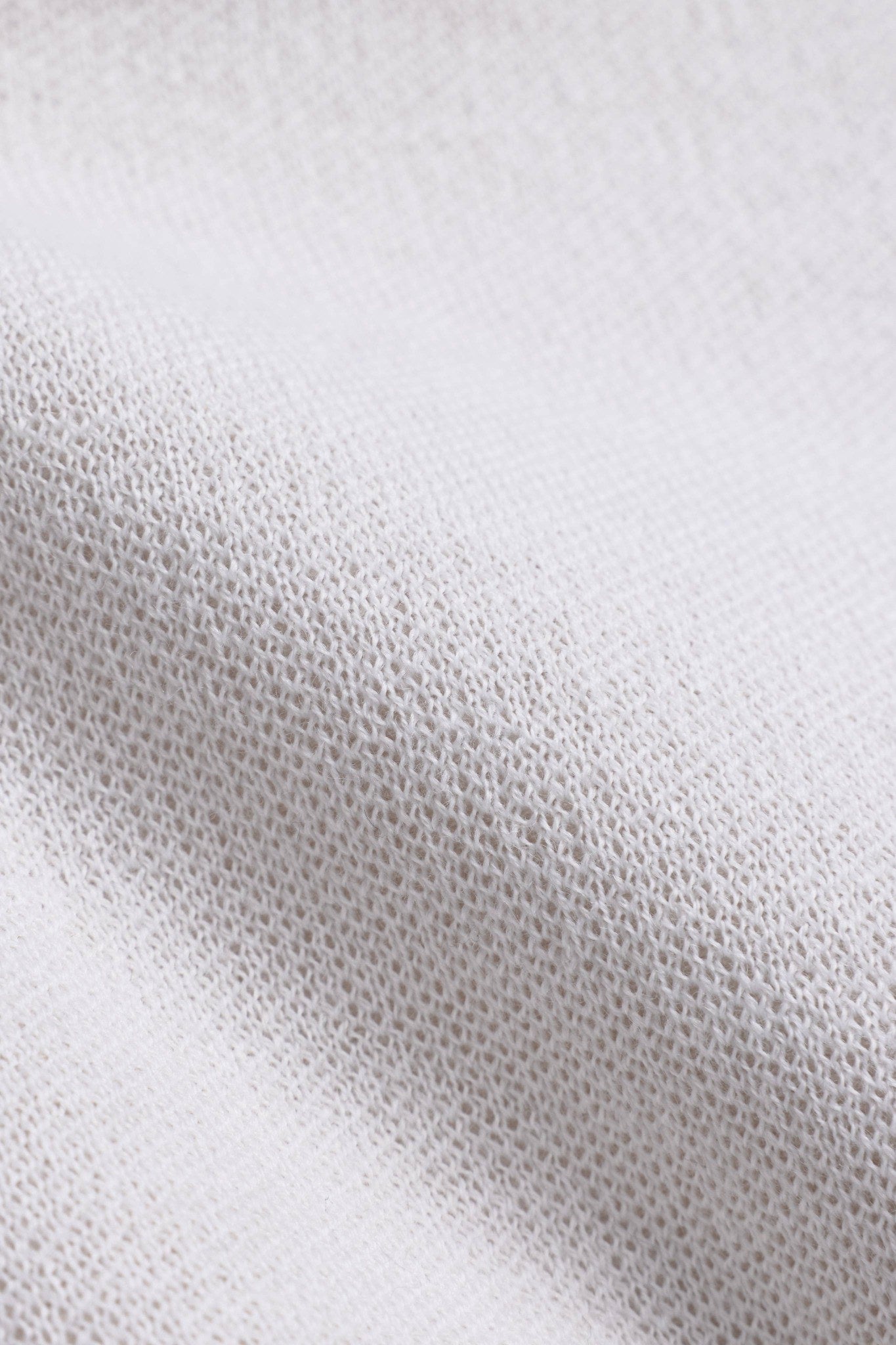 Close-up of the soft creme wool-blend knit texture on the CASPARA Classic Neckwarmer.