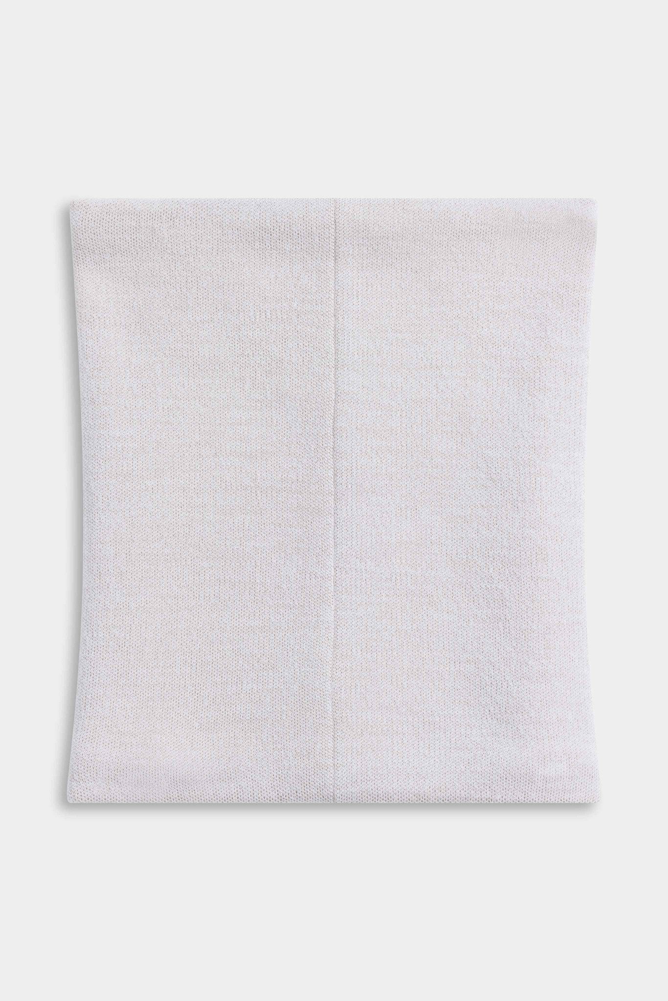 CASPARA Classic Neckwarmer in creme knit laid flat, showing the back seam.