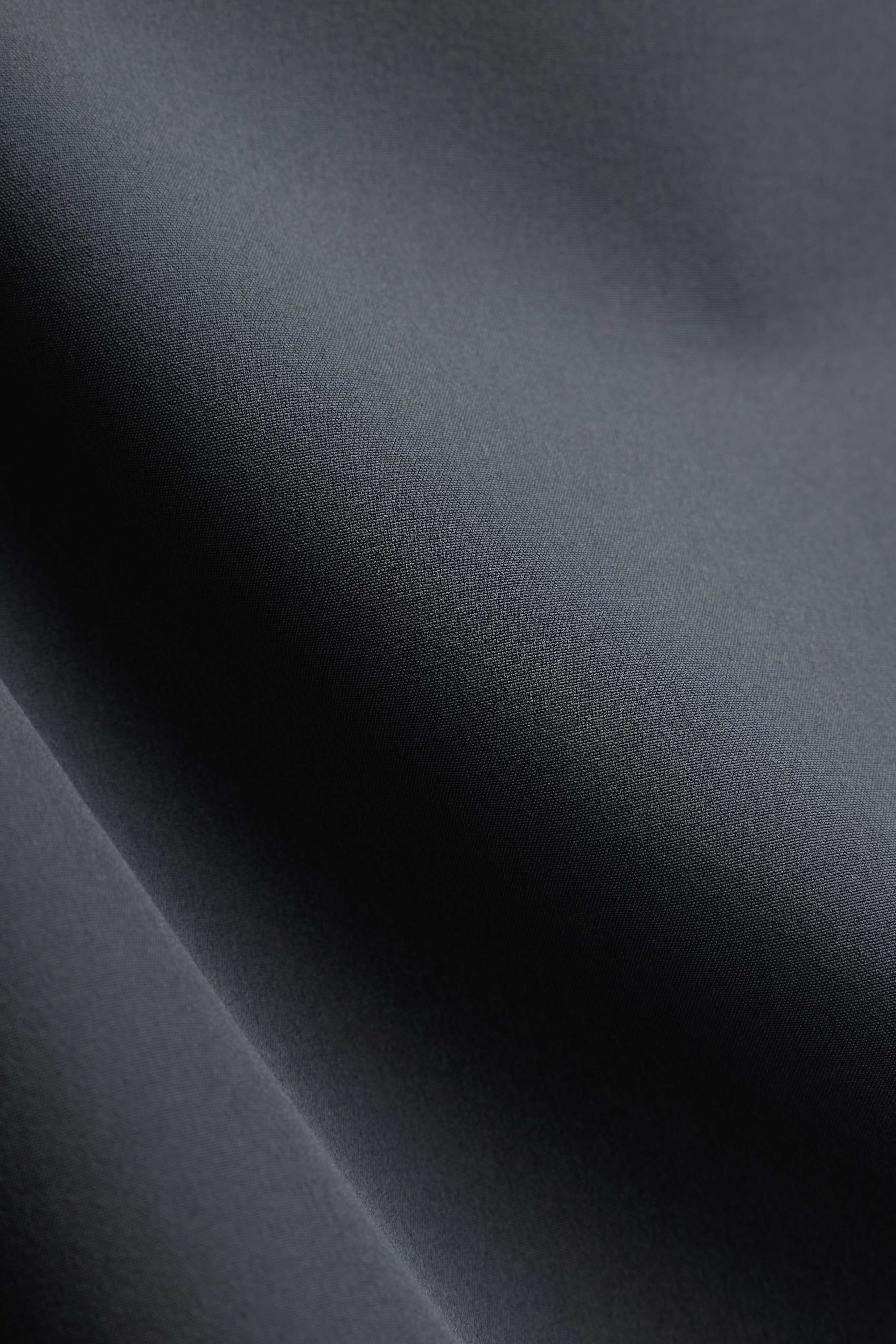 Close-up of the smooth olive green fabric texture on CASPARA Prime Core Pants.