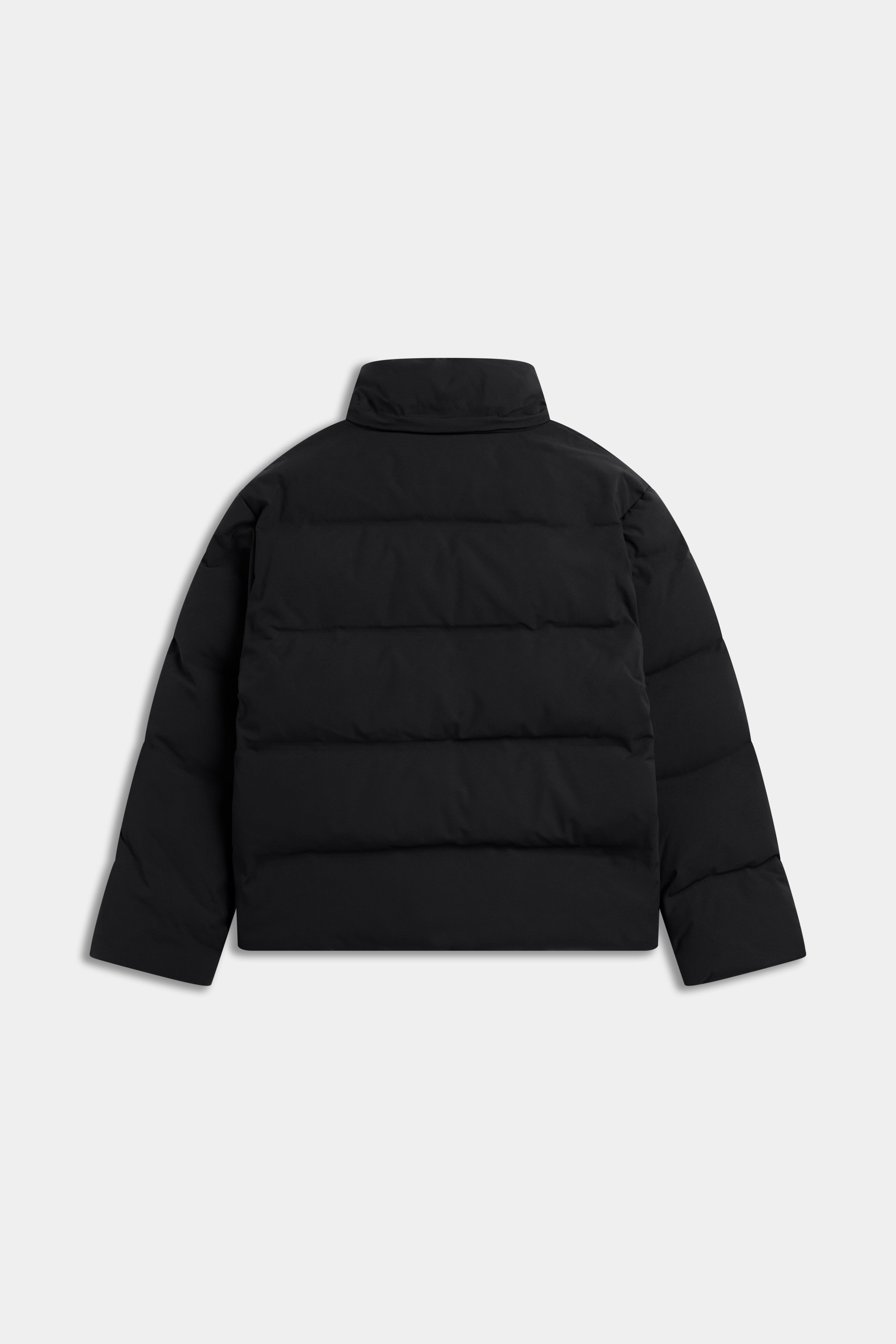 Back view of the black CASPARA M. Boreal Puffer Jacket on a light grey background.