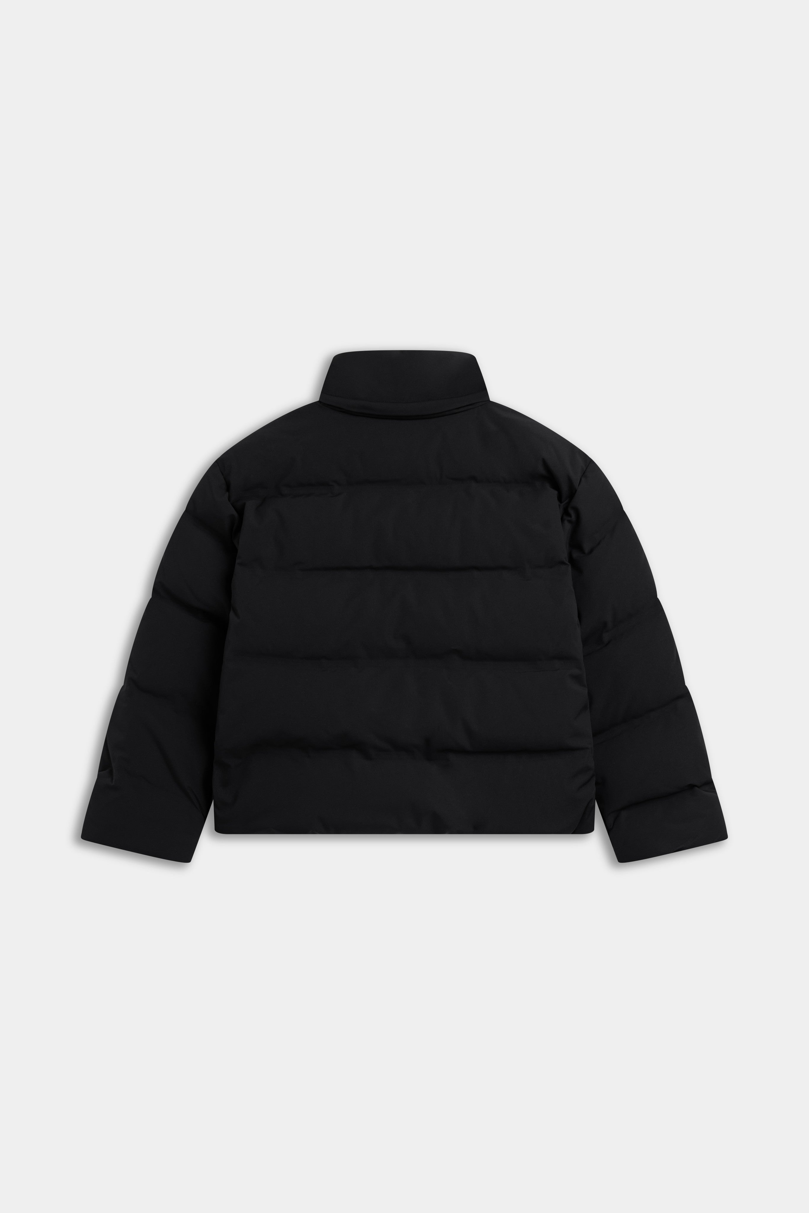 Back view of the black CASPARA Aurora puffer jacket with horizontal quilting.