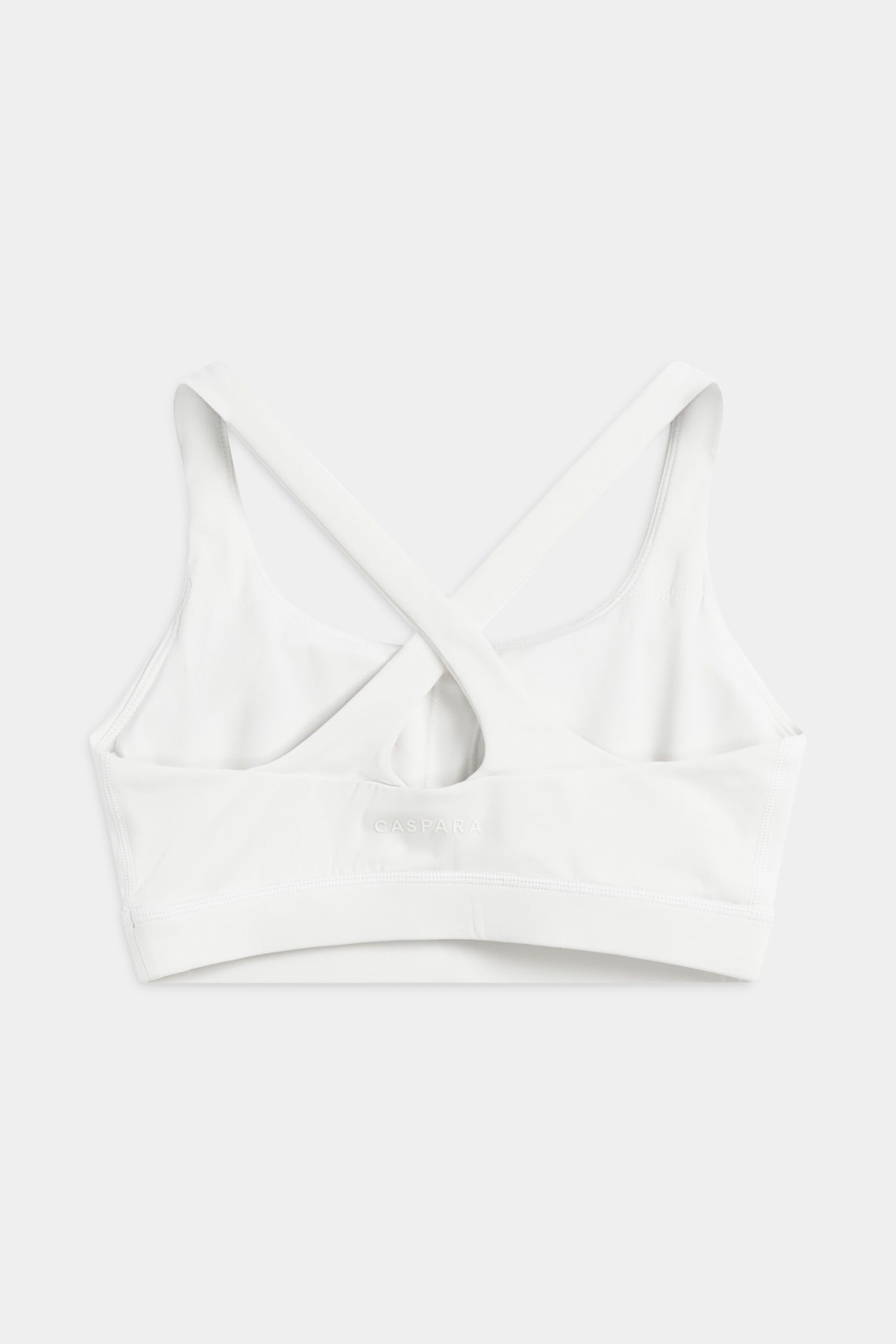 Back view of the white CASPARA Cloudform crossback sports bra.